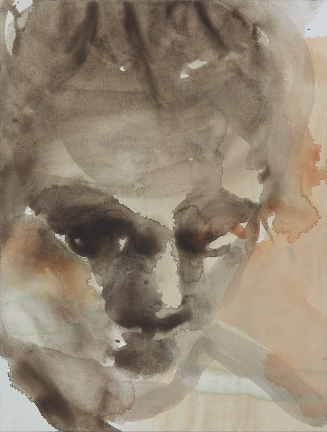 A watercolor painting of a woman's face on a piece of paper.