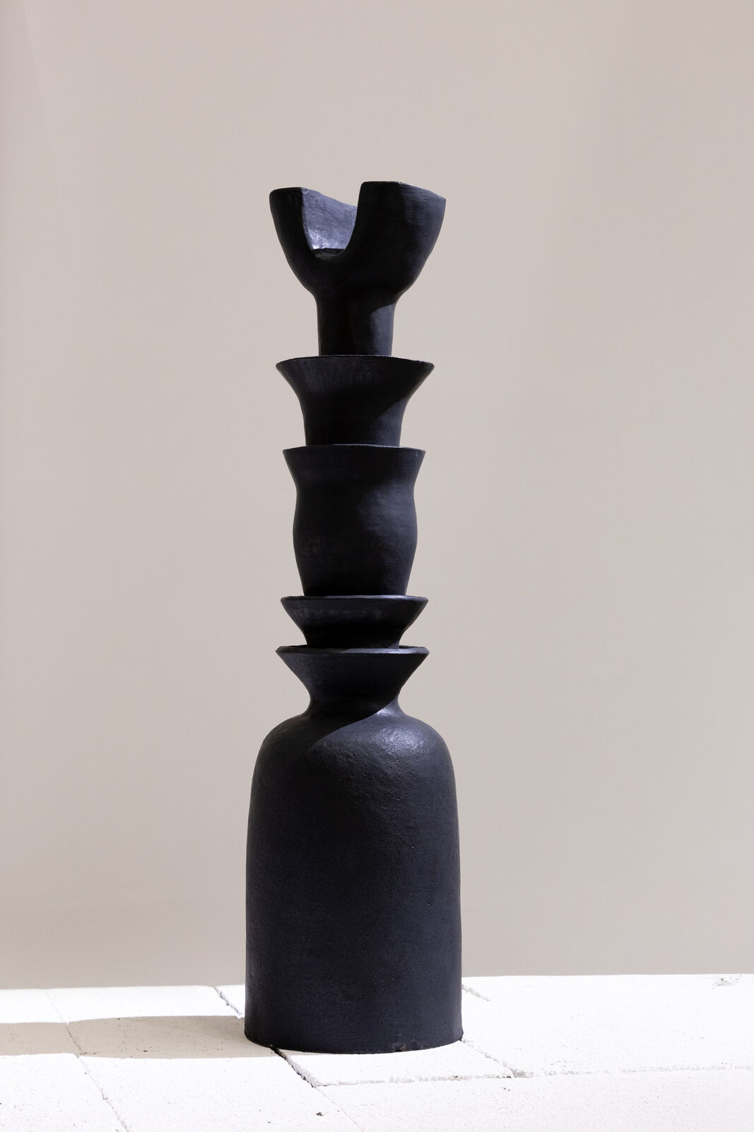 Artwork by Dina Nur Satti, Tower Lotus I, Made of Red sculpture clay, black glaze 