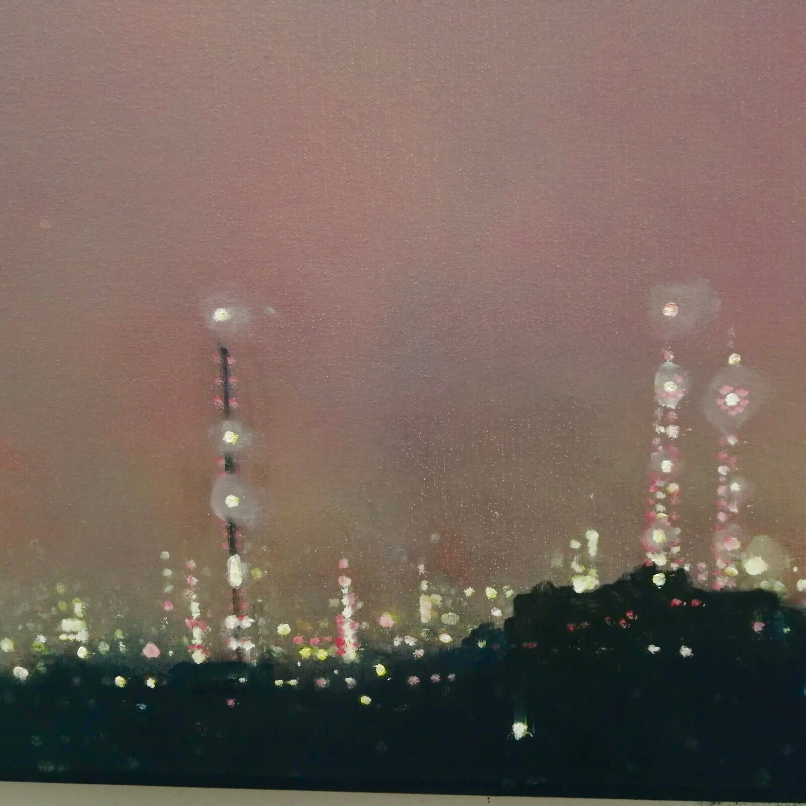 A moody night cityscape under a hazy, pink-hued sky with a bright celestial body.