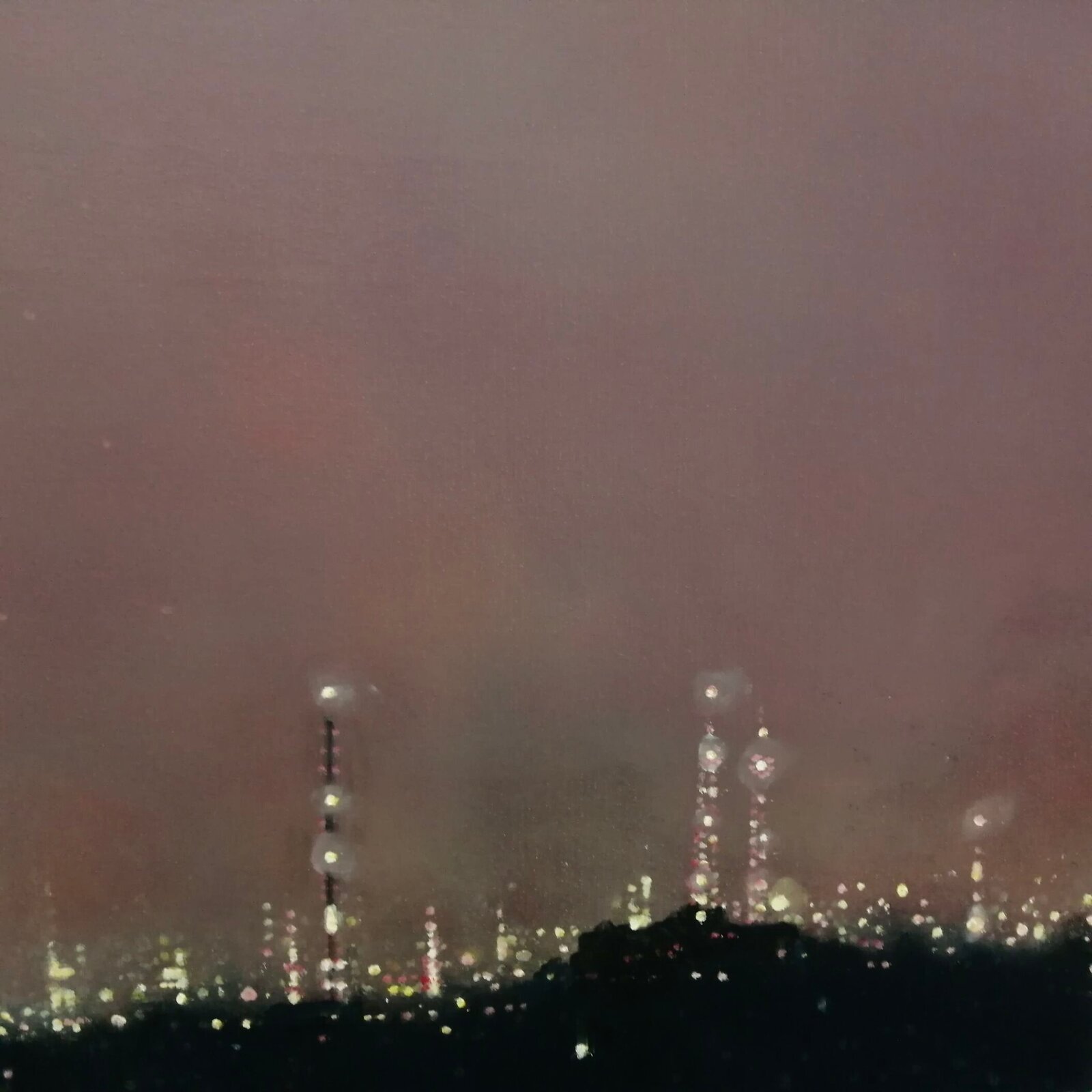 A moody night cityscape under a hazy, pink-hued sky with a bright celestial body.