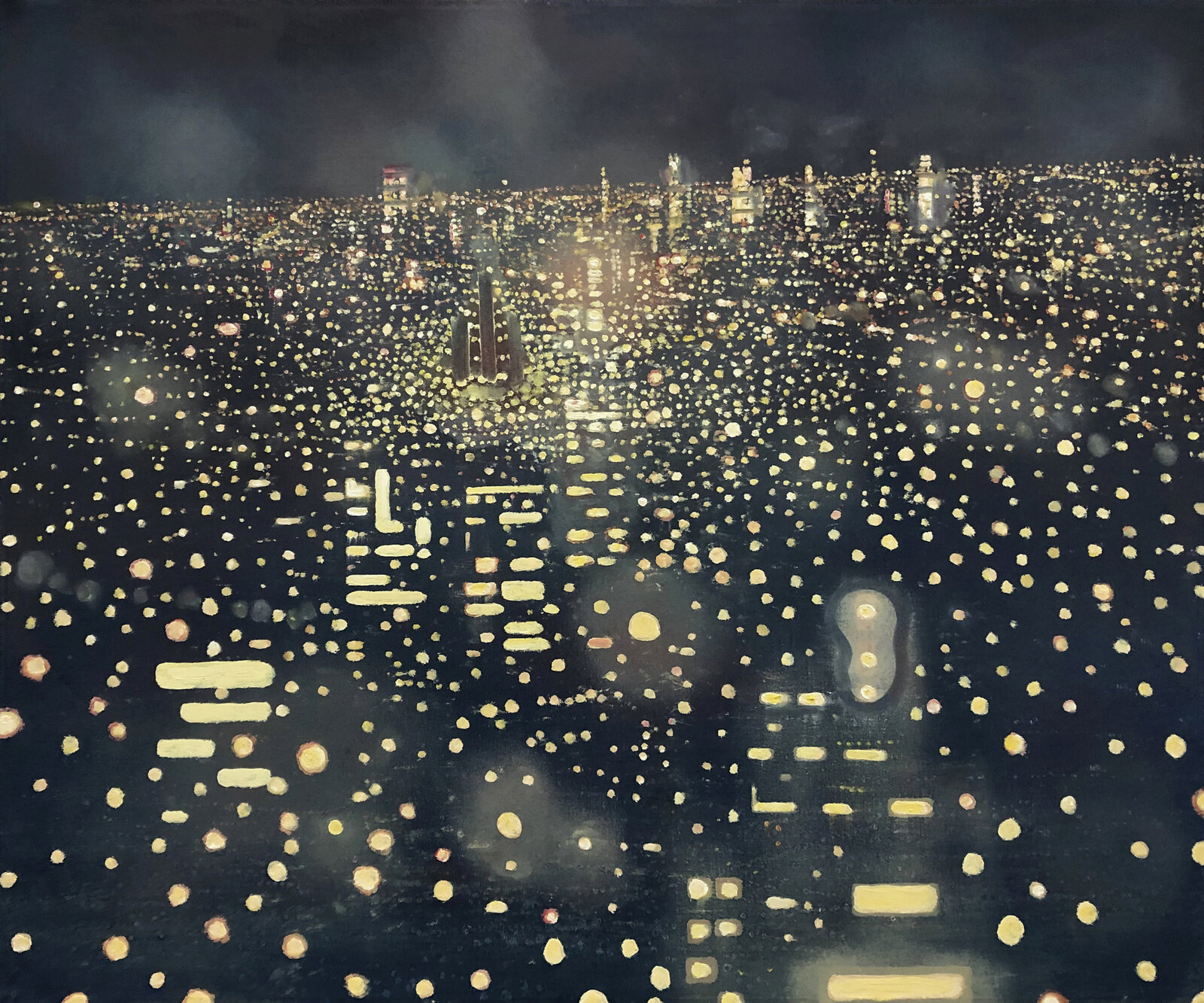 A nocturnal cityscape viewed through a rain-streaked window, where countless lights reflect on the dark surface.