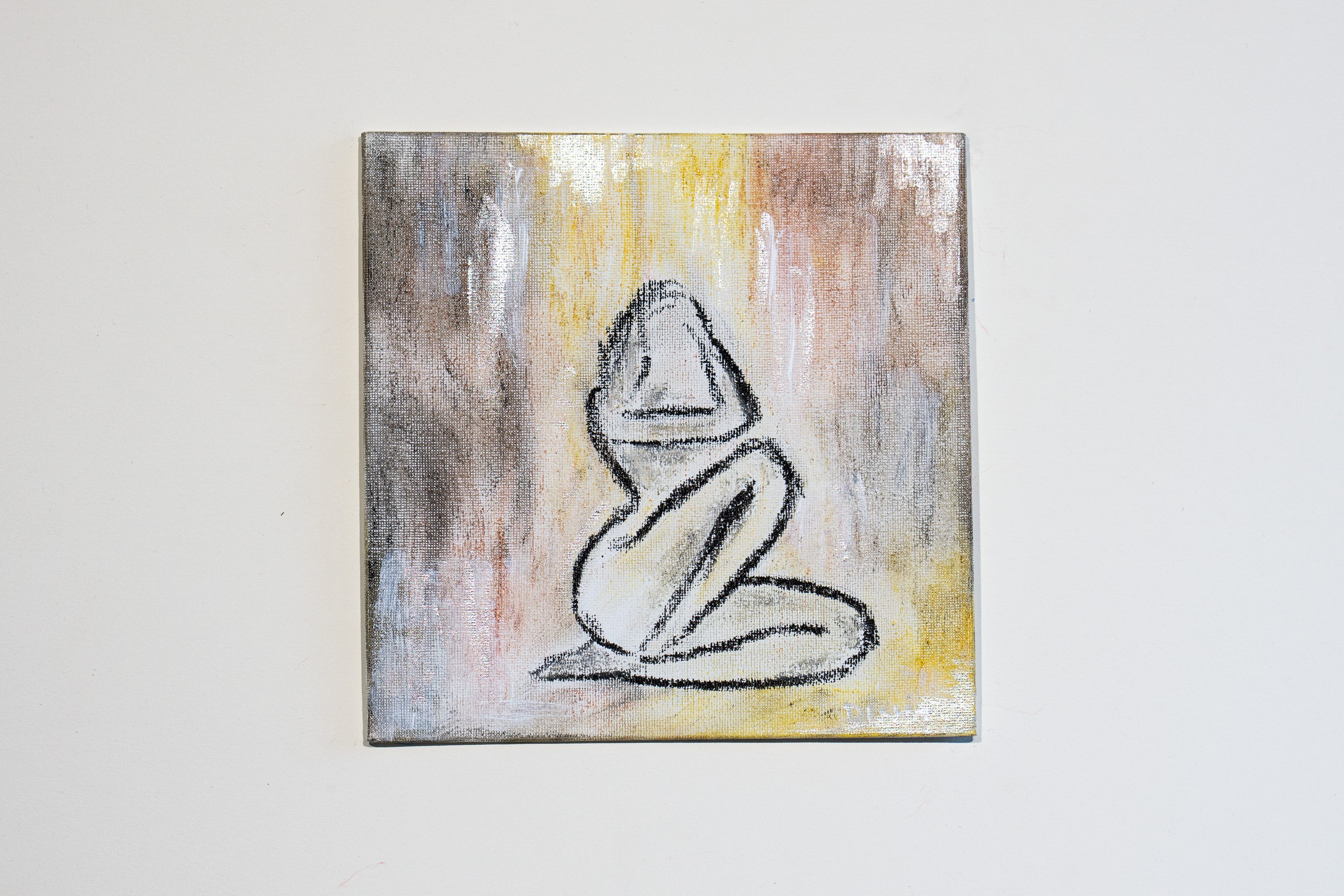 A painting of a person sitting in a lotus position on a wall.