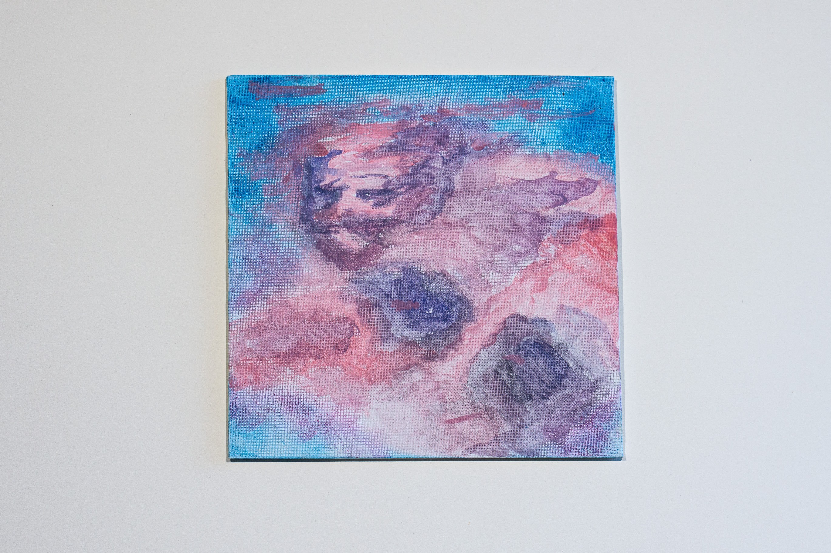 A painting on a white wall with a blue background.