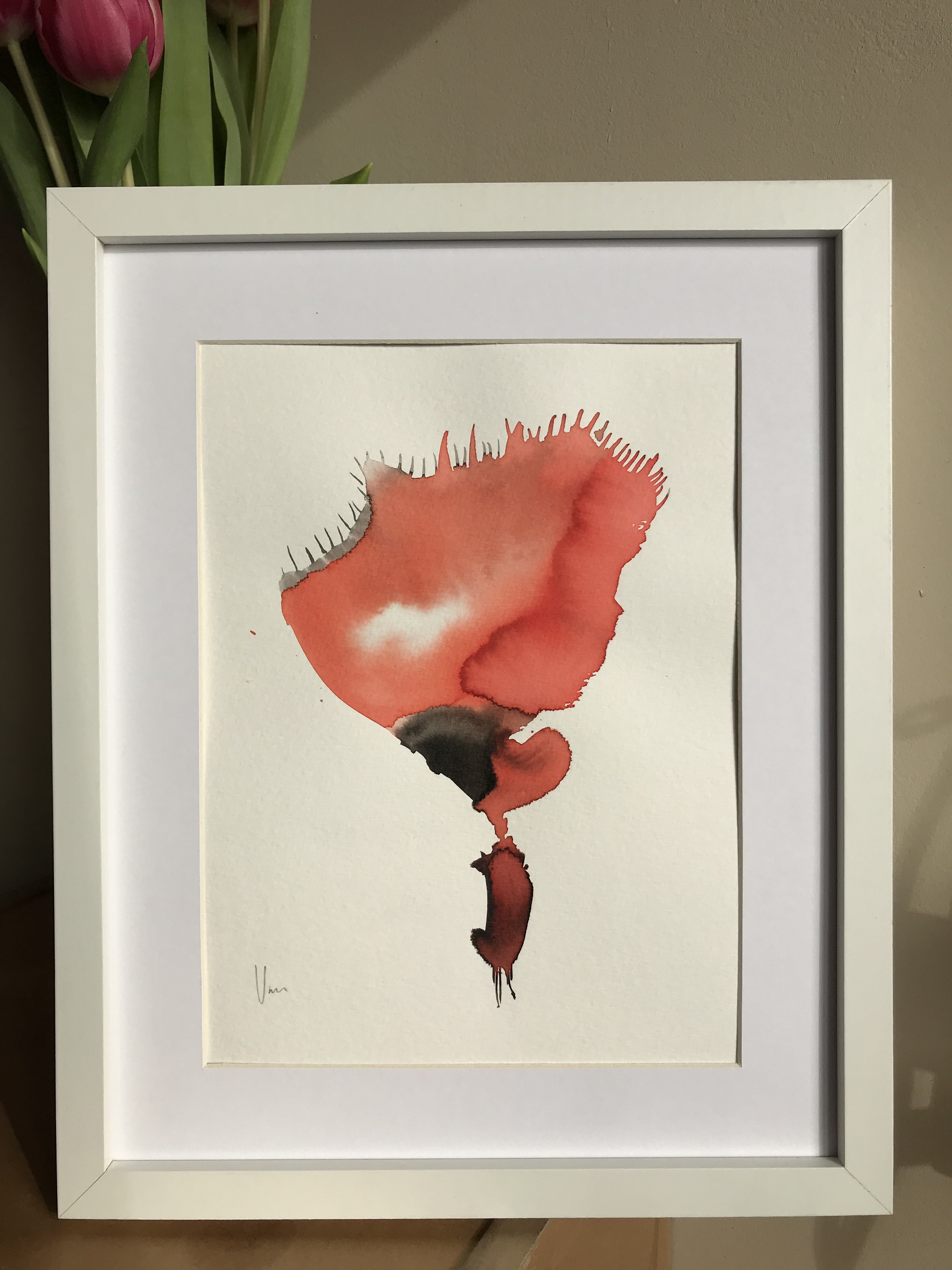 A watercolor painting of a red flower in a white frame.