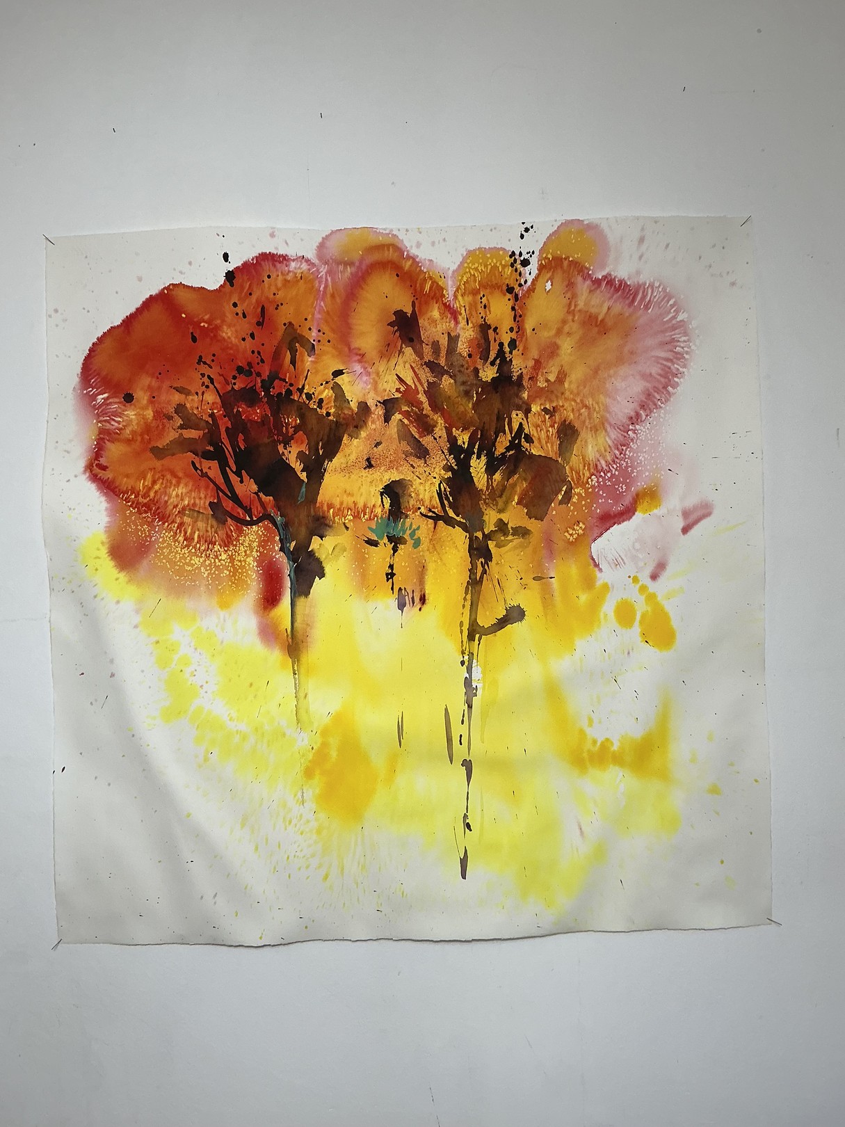 A watercolor painting of two trees on a white wall.