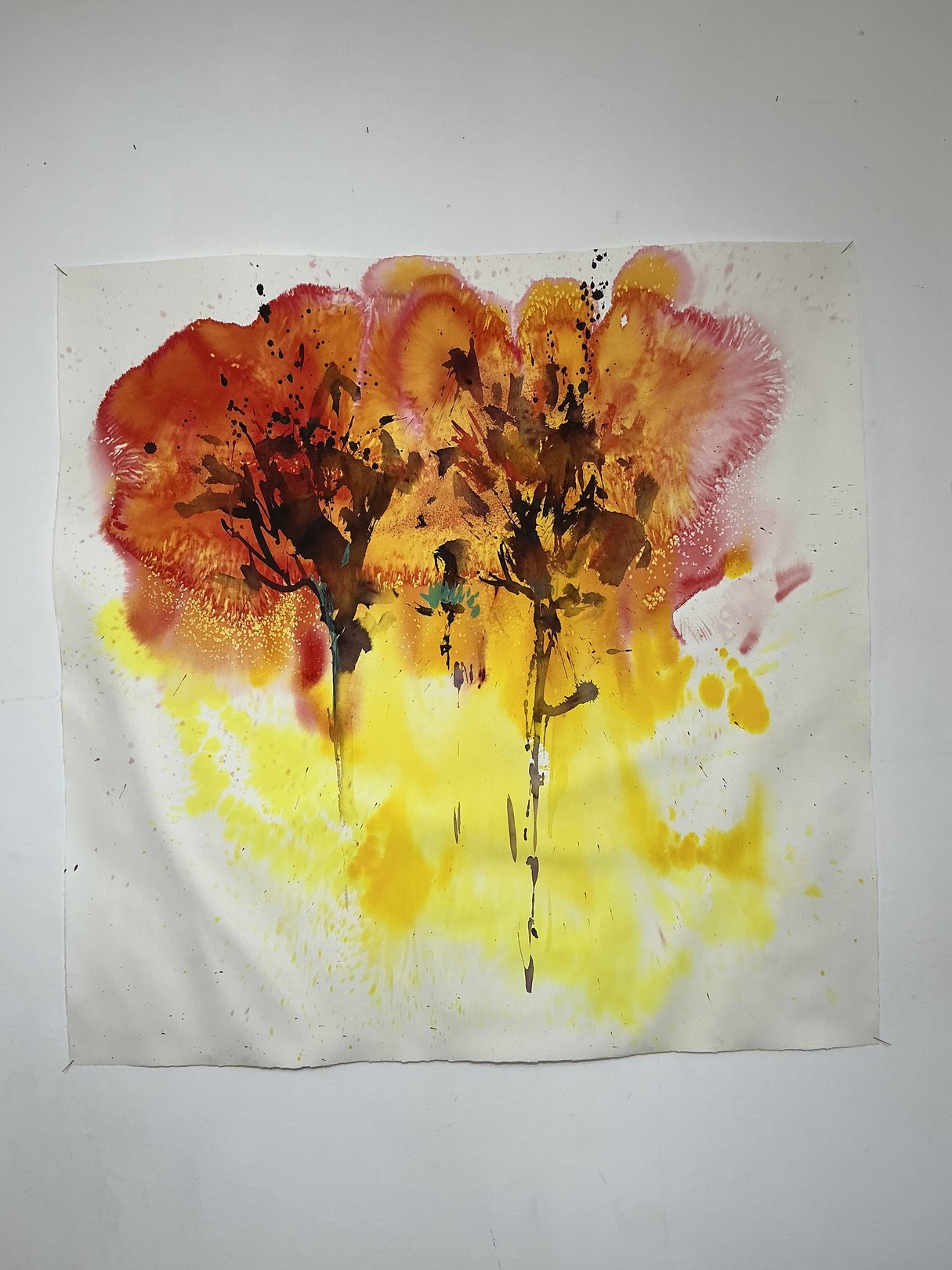 A watercolor painting of two trees on a white wall.