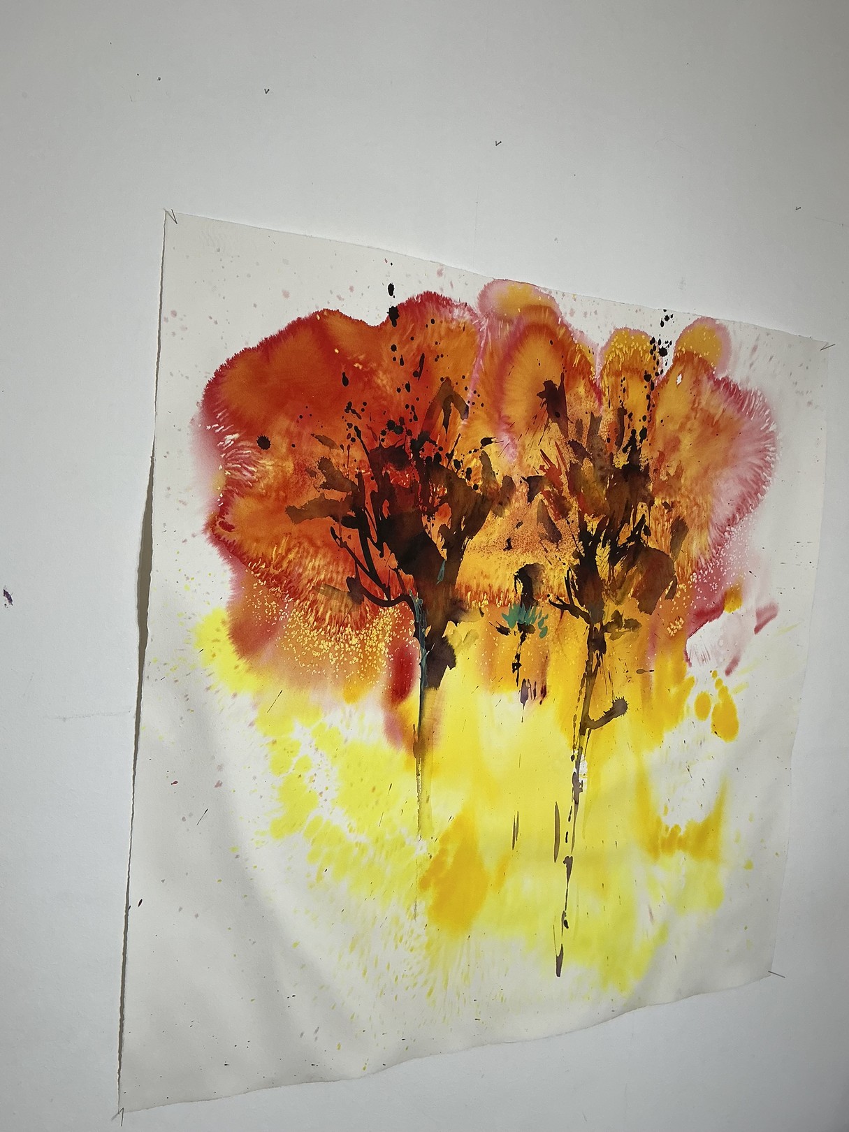 A watercolor painting of two trees on a white wall.