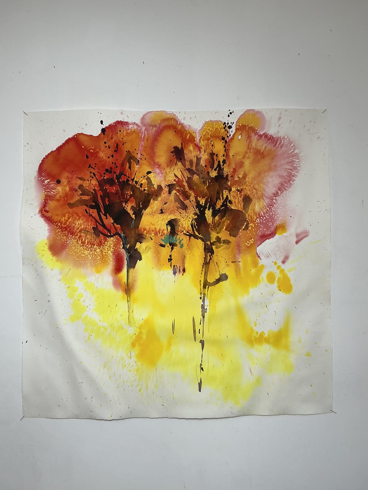 A watercolor painting of two trees on a white wall.