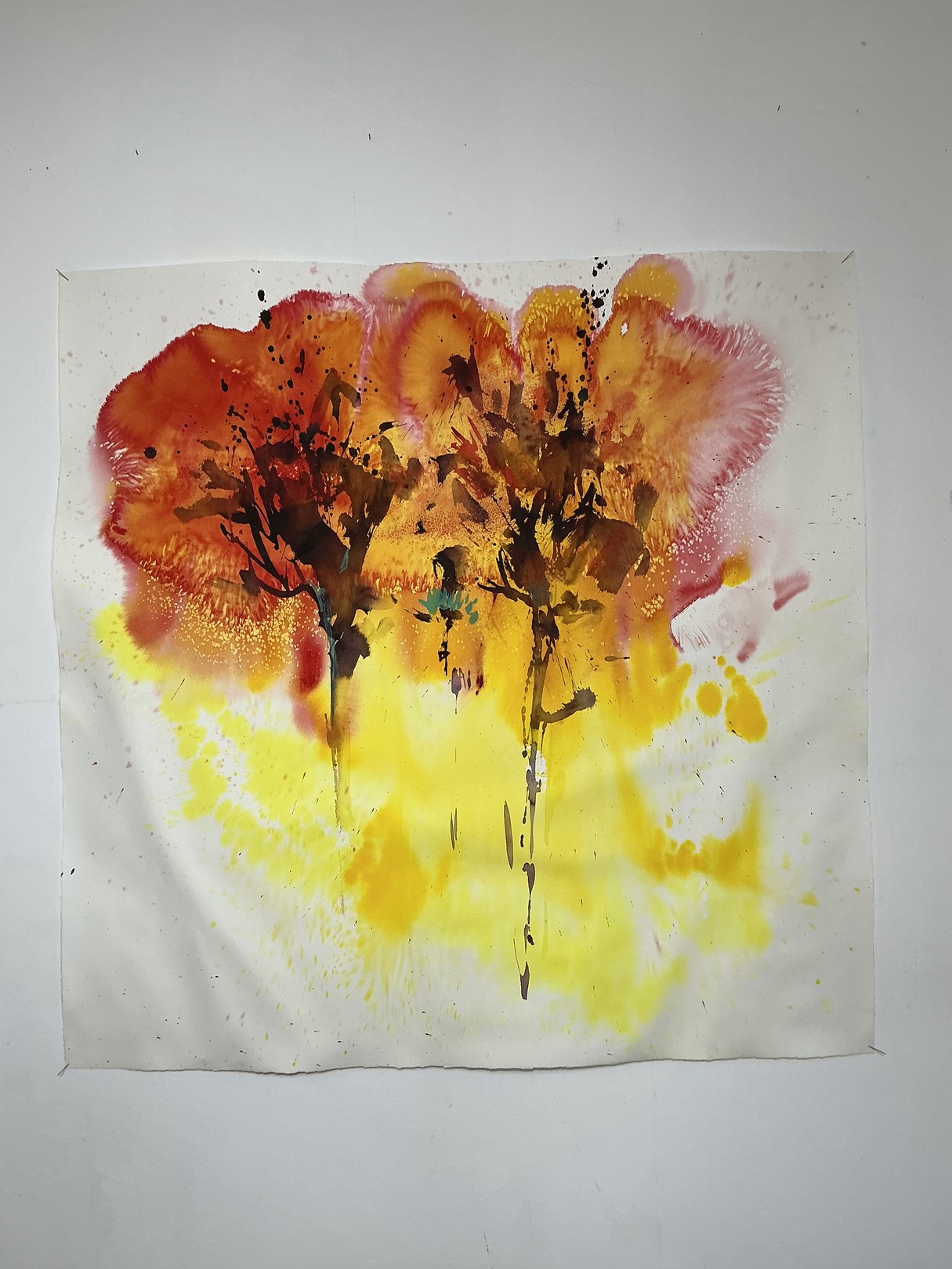 A watercolor painting of two trees on a white wall.