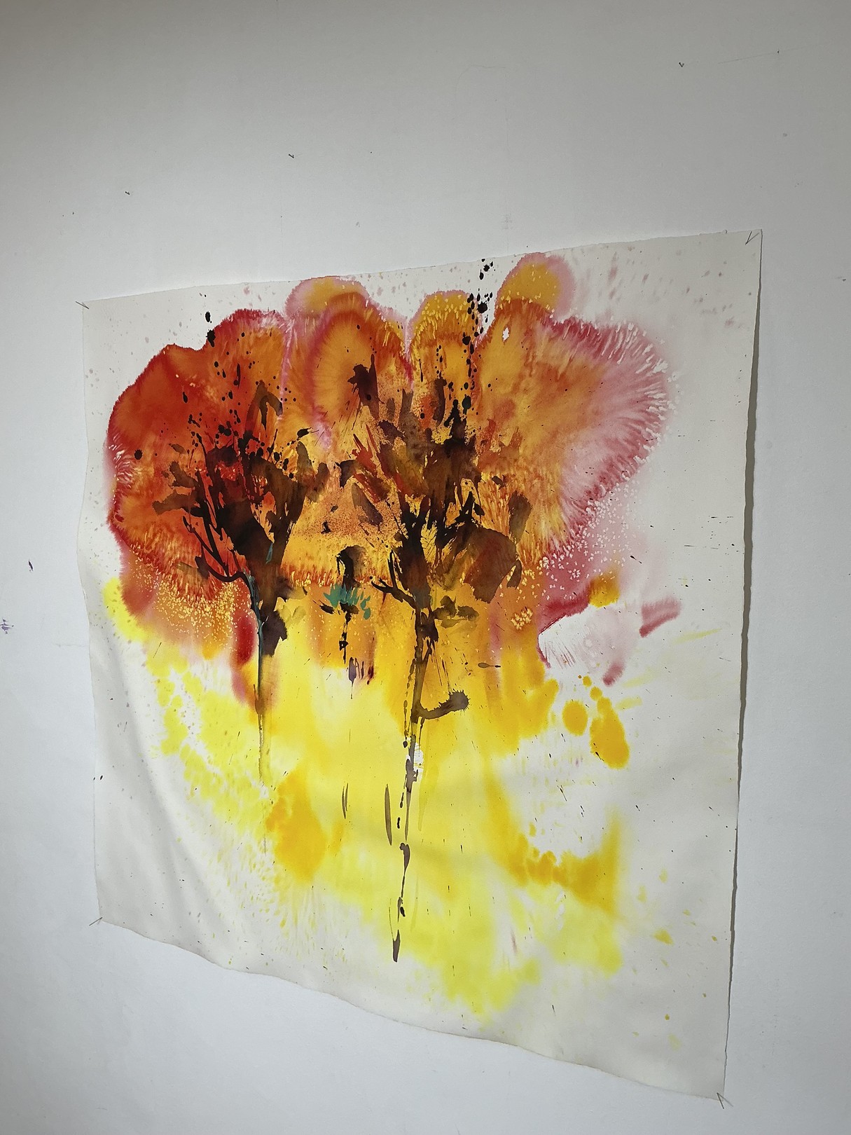 A watercolor painting of two trees on a white wall.