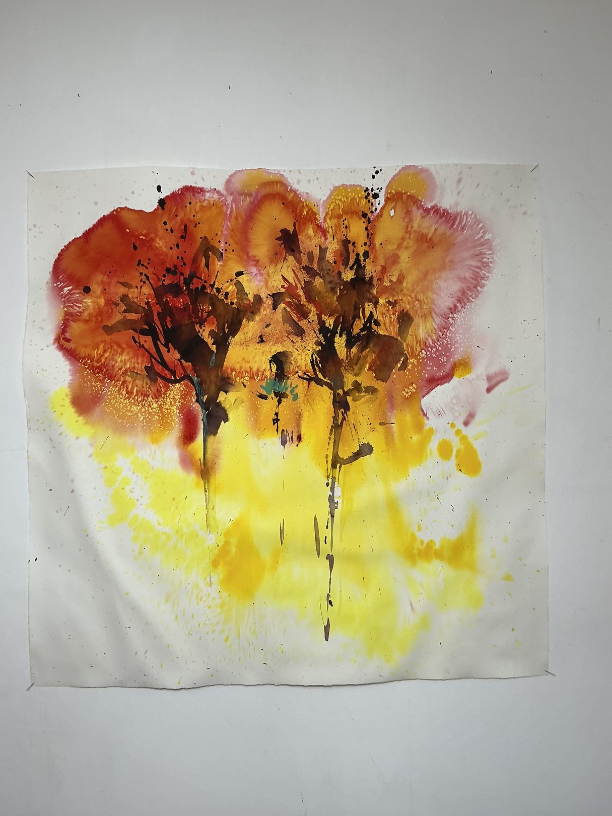 A watercolor painting of two trees on a white wall.