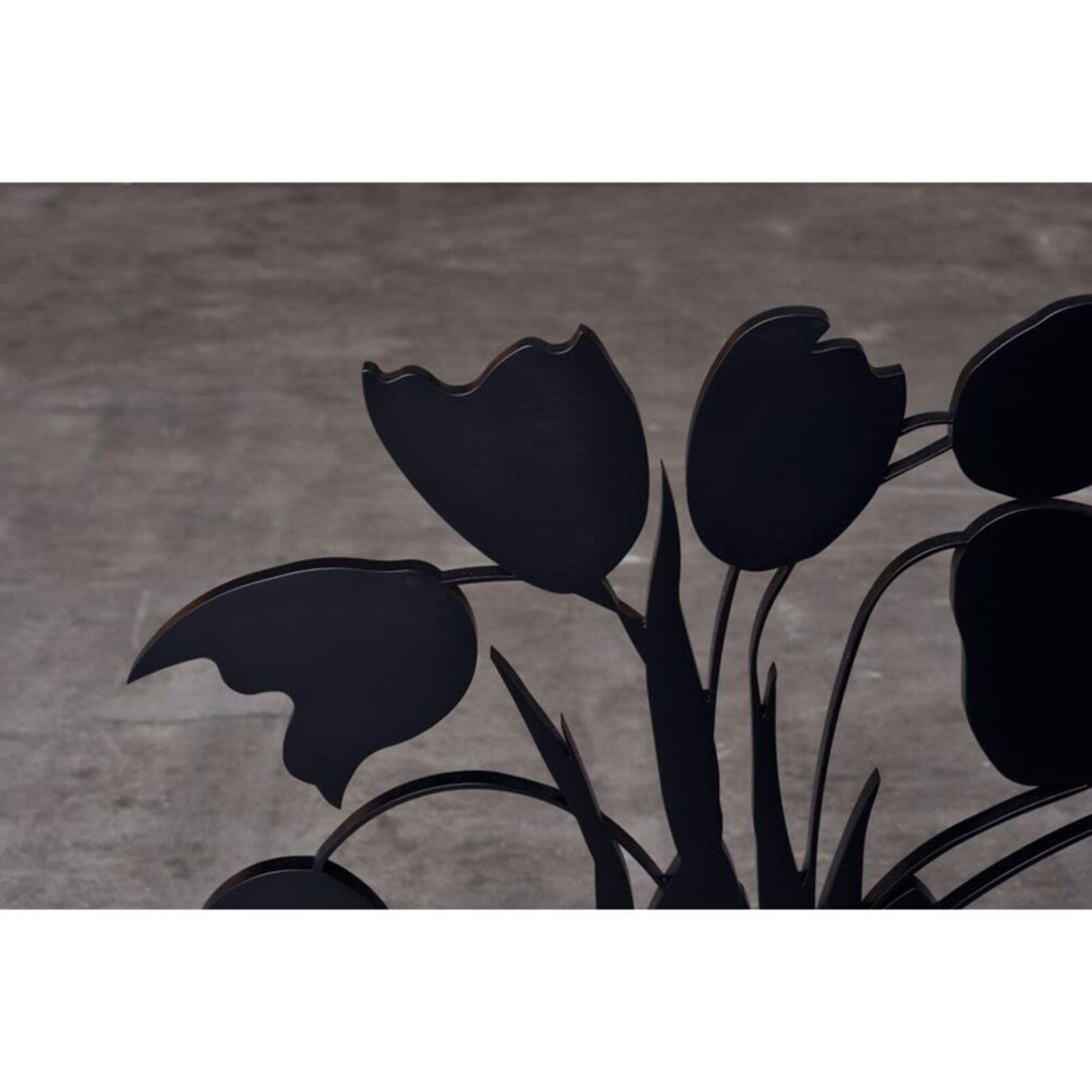 A black vase with a bunch of flowers in it.