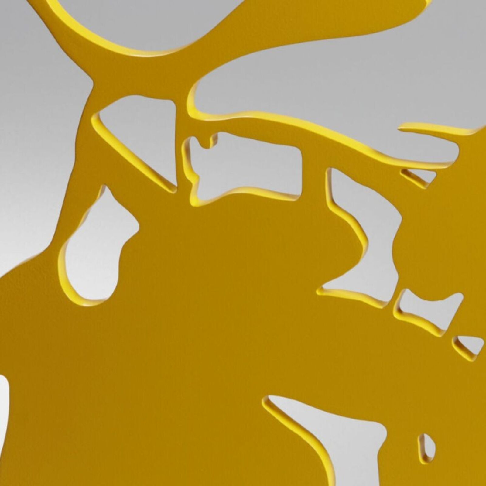 A yellow sculpture of a bunch of grapes on a metal stand.