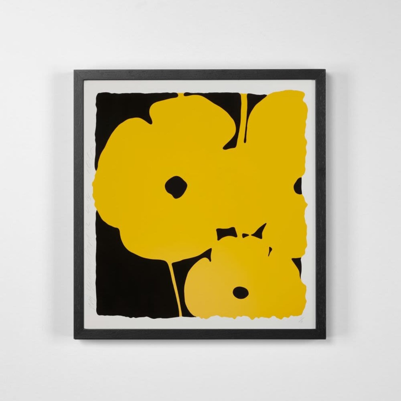 A bold graphic print featuring a large yellow flower against a black background.