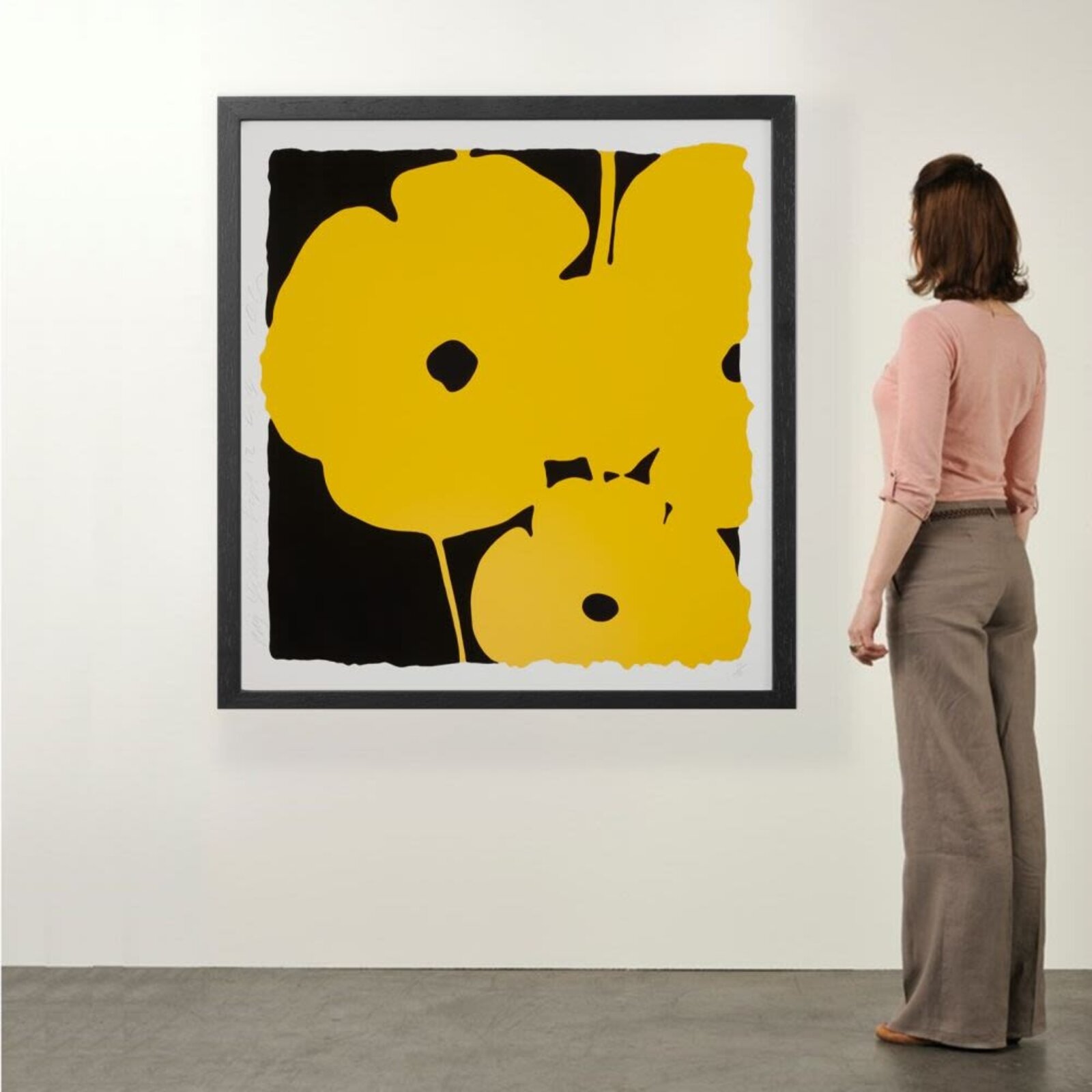 A bold graphic print featuring a large yellow flower against a black background.