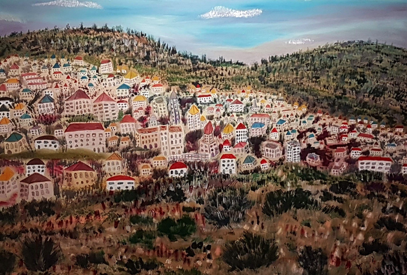 A painting of a city on a hillside with mountains in the background.