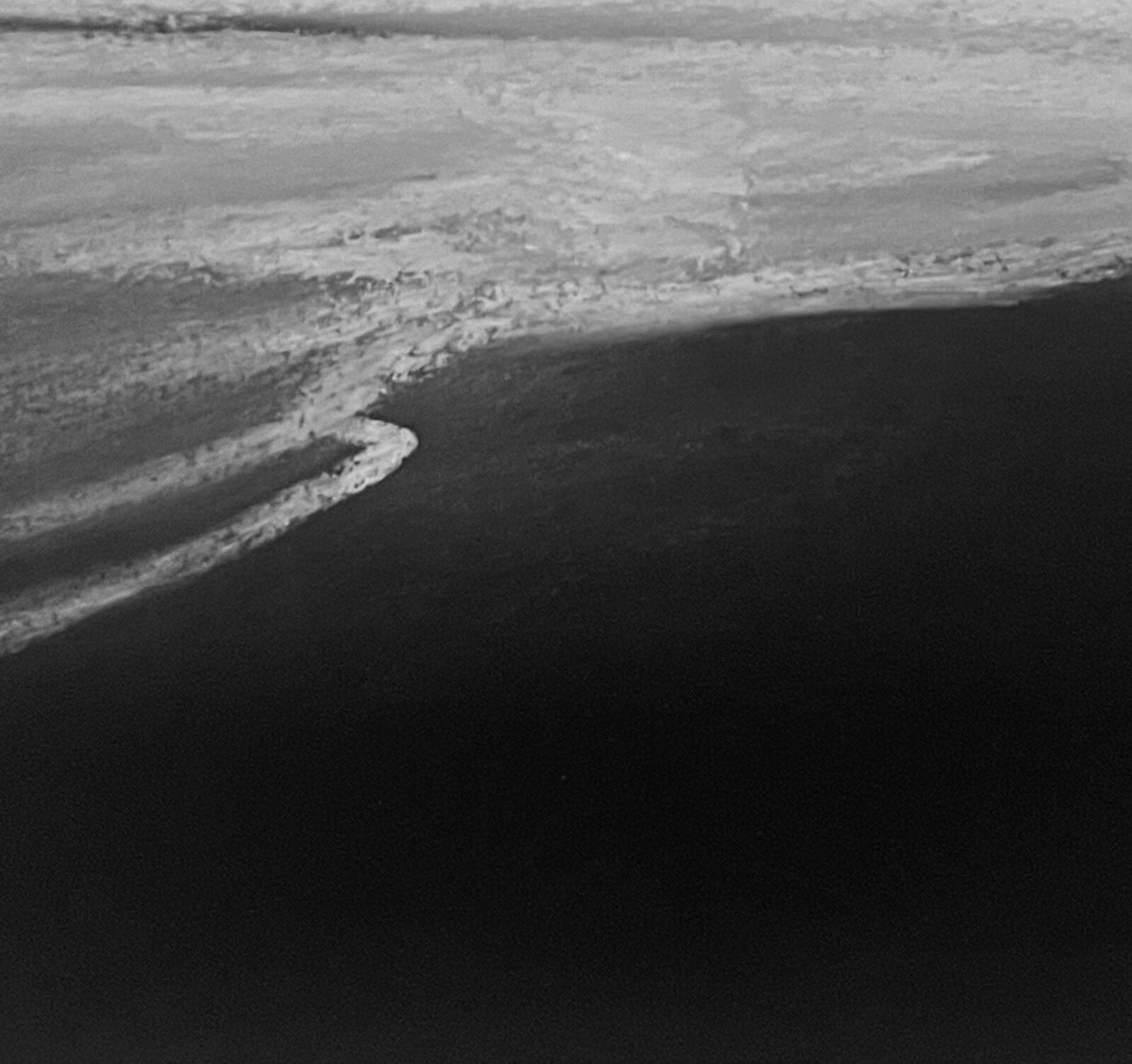A monochromatic seascape capturing the raw power of a stormy ocean.