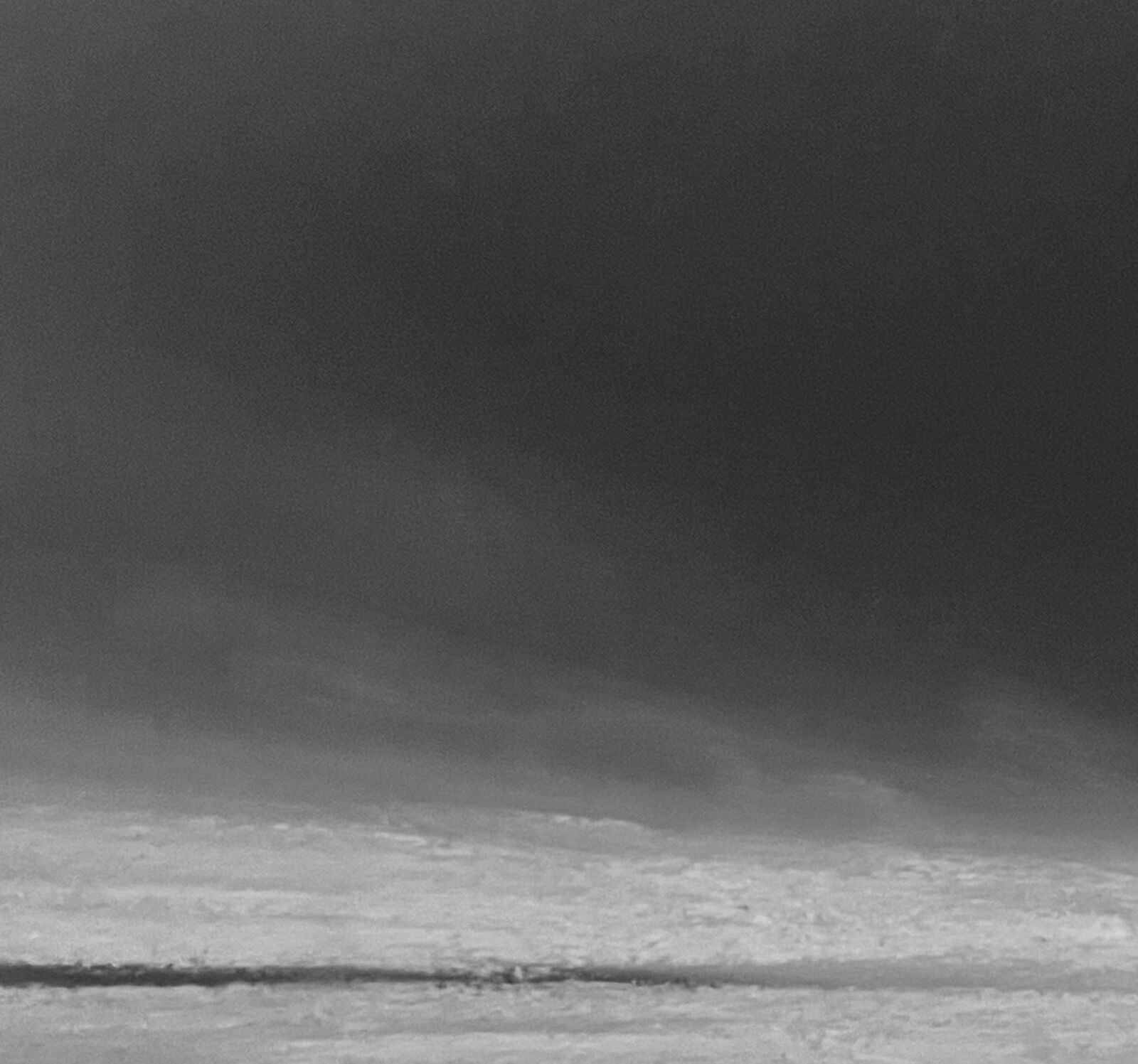 A monochromatic seascape capturing the raw power of a stormy ocean.