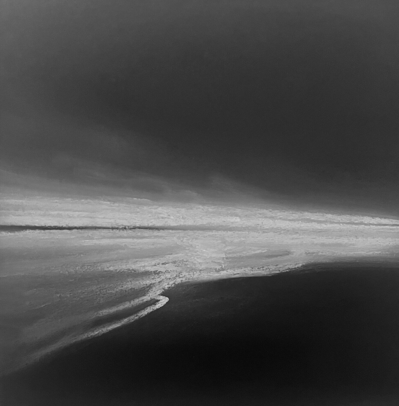 A monochromatic seascape capturing the raw power of a stormy ocean.