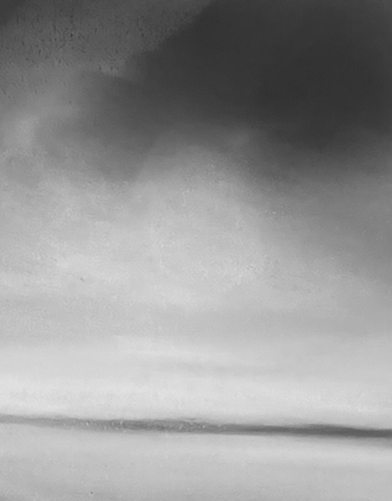 A monochromatic seascape painting depicting a dark, jagged coastline under a vast, cloudy sky.