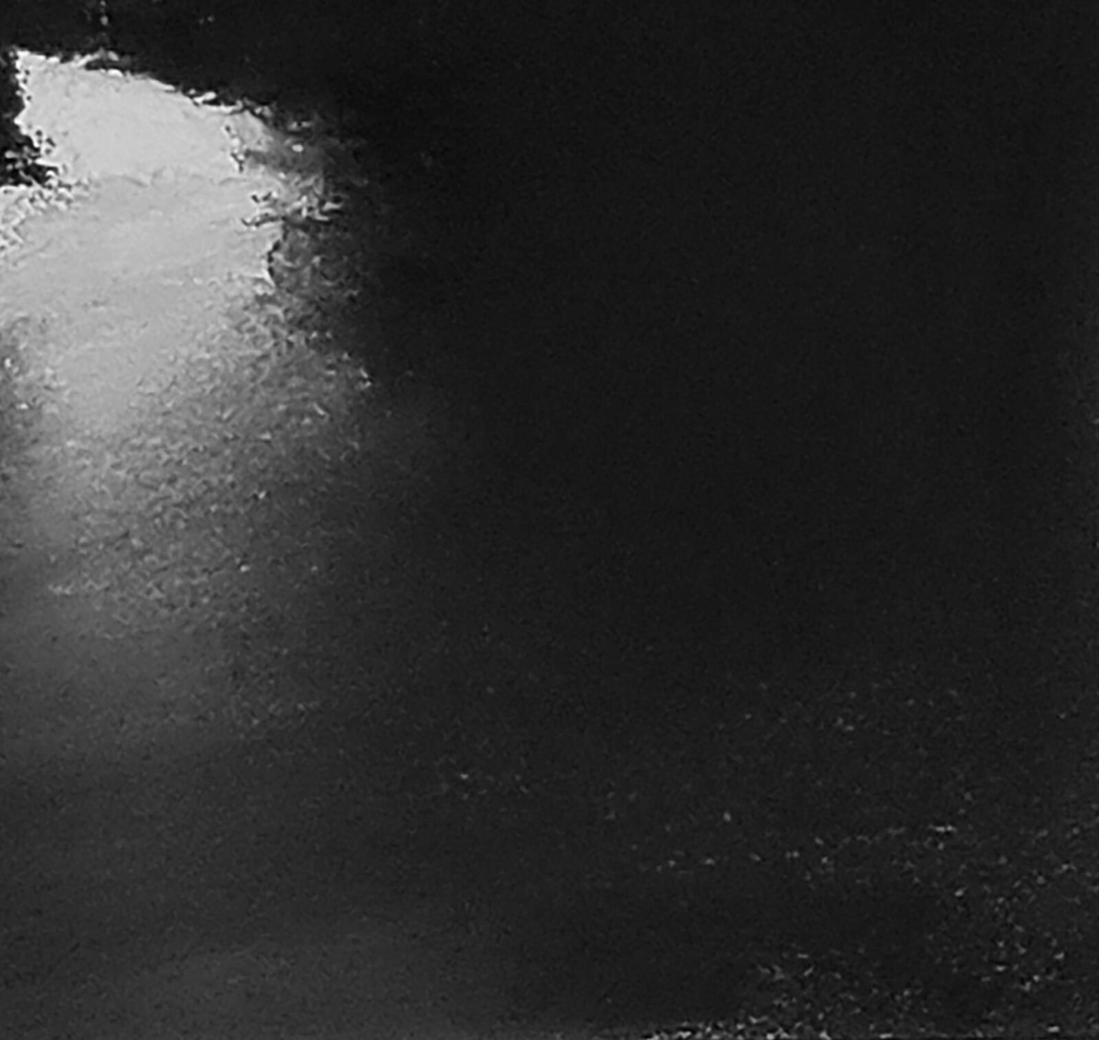 A monochromatic landscape painting depicting a river reflecting a bright sky between dark silhouettes.