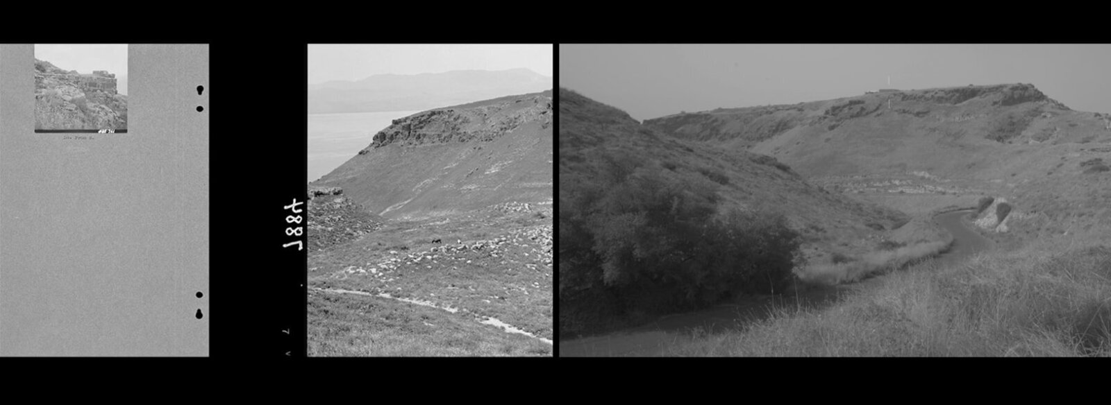 A black and white photo of a dirt road in the middle of a mountain.