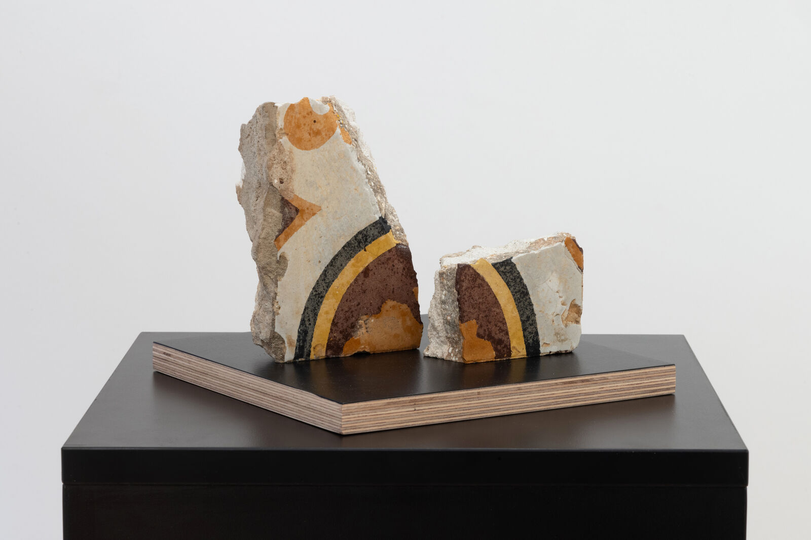 A couple of pieces of art sitting on top of a table.