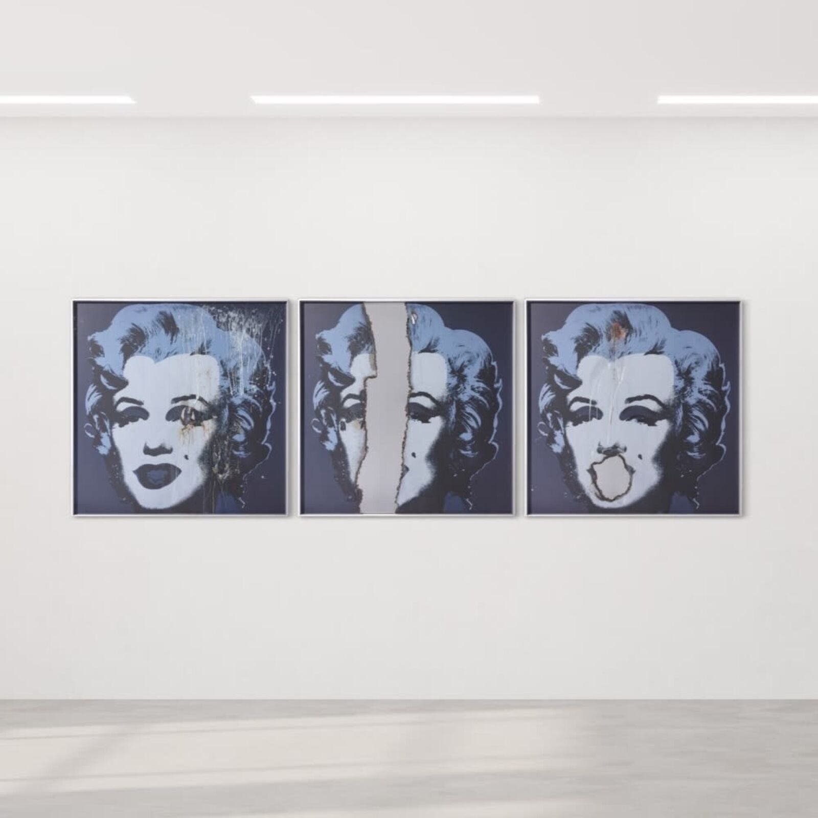 Three paintings of Marilyn Monroe on a wall in a room.