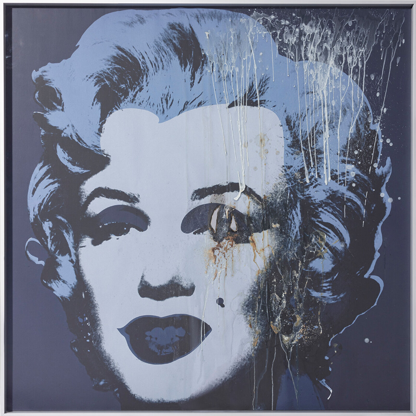 Three paintings of Marilyn Monroe on a wall in a room.