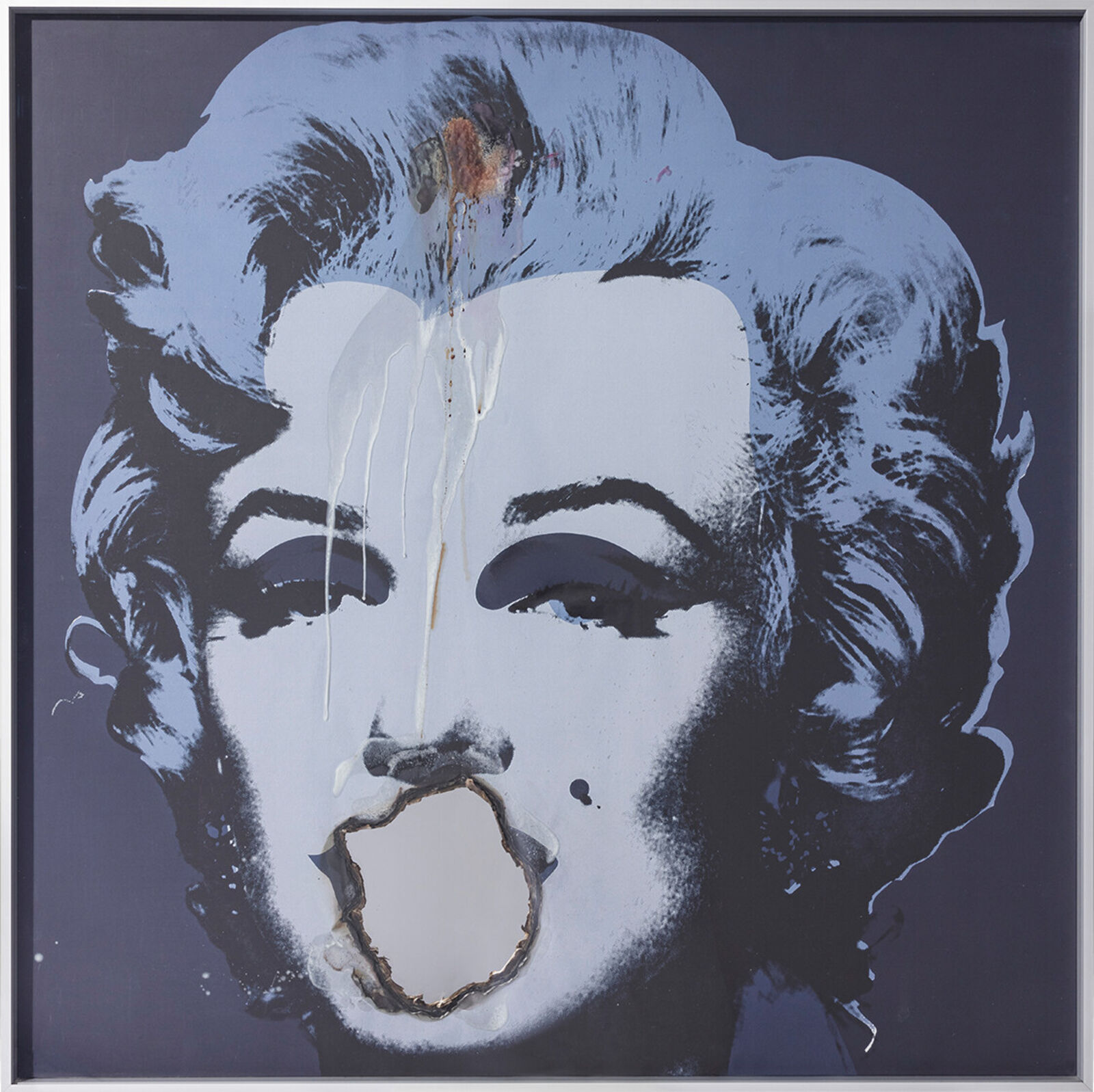 Three paintings of Marilyn Monroe on a wall in a room.