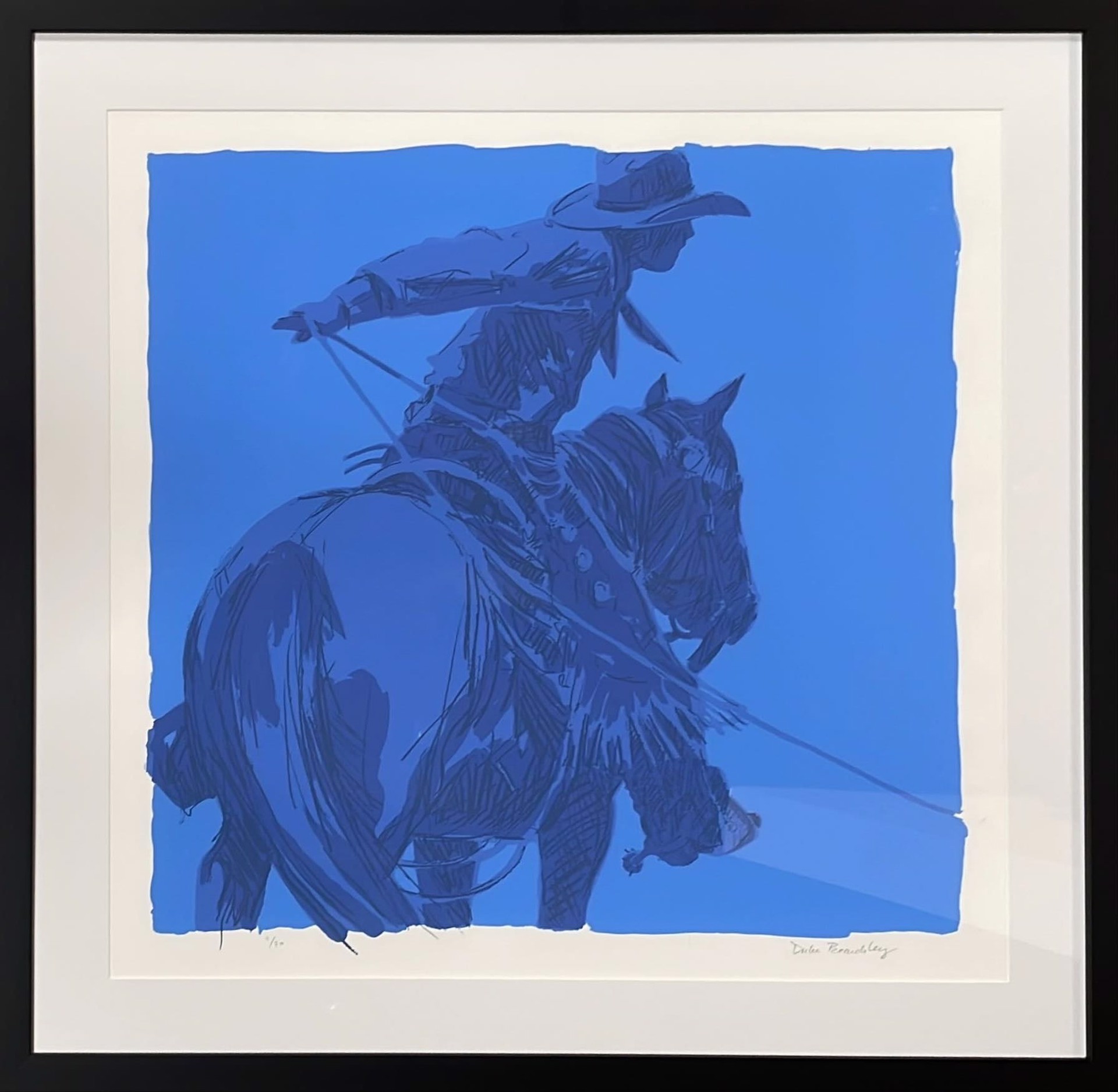 A blue and white drawing of a cowboy on a horse.
