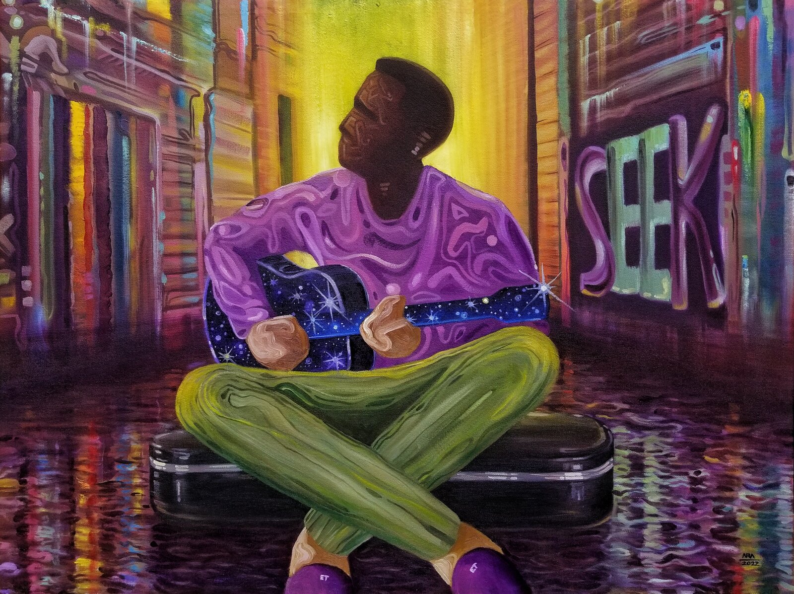 A figure sits cross-legged on a black case in a vibrant, graffiti-lined alleyway, holding an acoustic guitar.