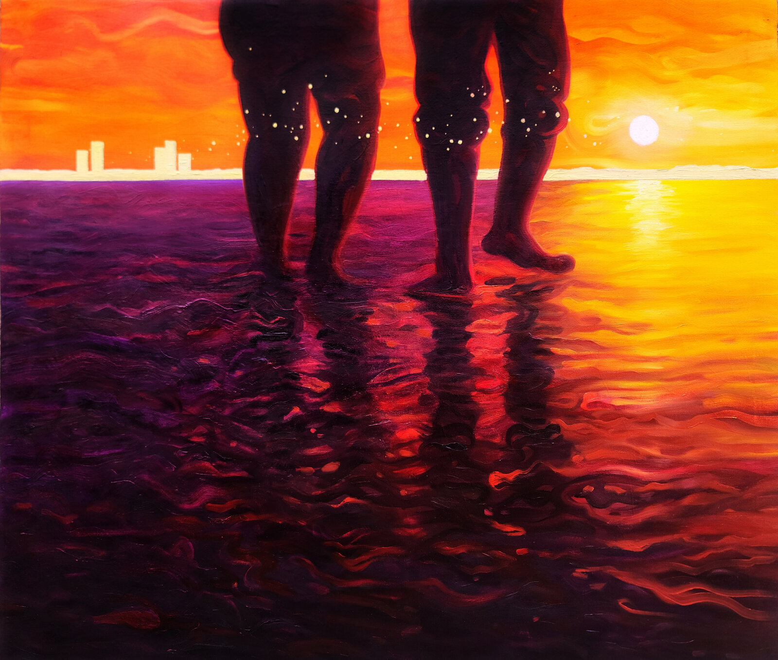 "A pair of figures stand barefoot in the water at sunset, their silhouettes reflected in the rippling surface against a vibrant orange sky and distant city skyline."