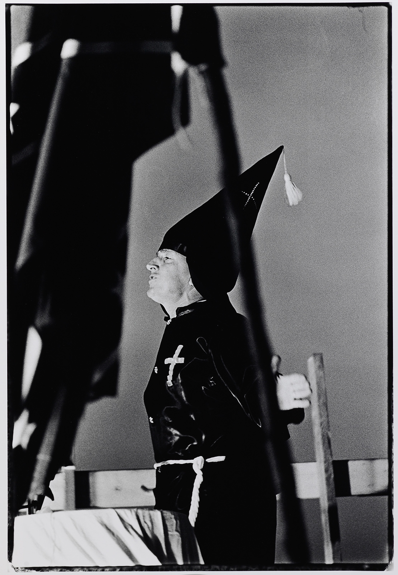 A black and white photo of a man in a priest's hat.