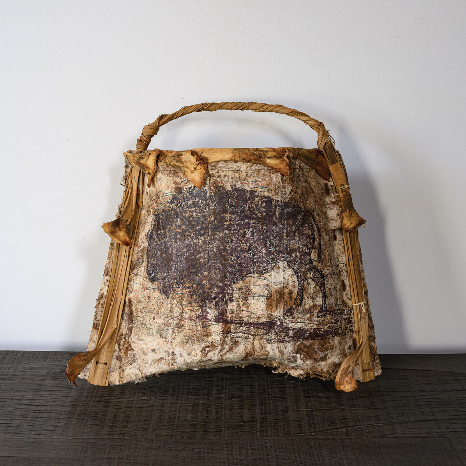 A brown and white bag sitting on top of a wooden table.
