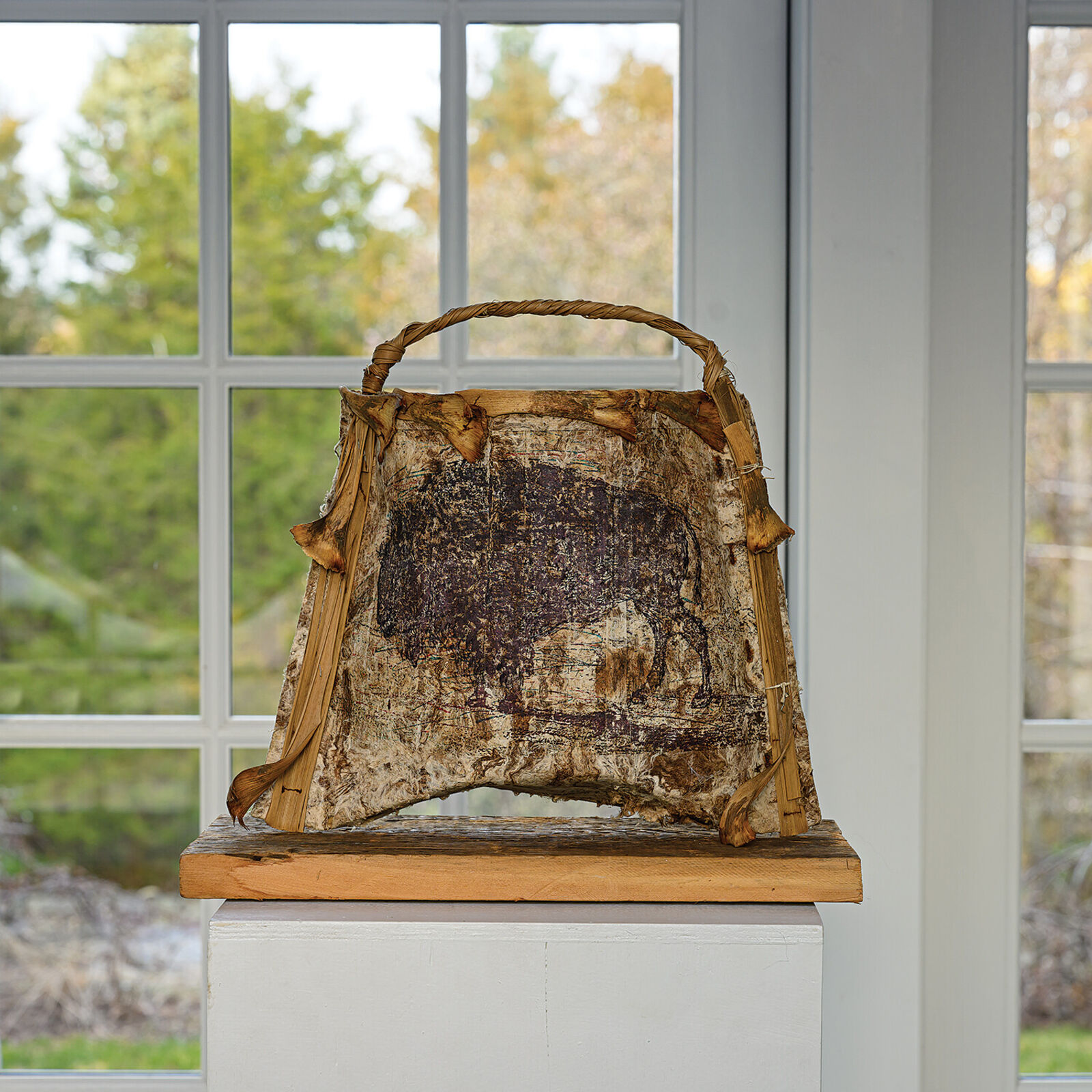 A brown and white bag sitting on top of a wooden table.