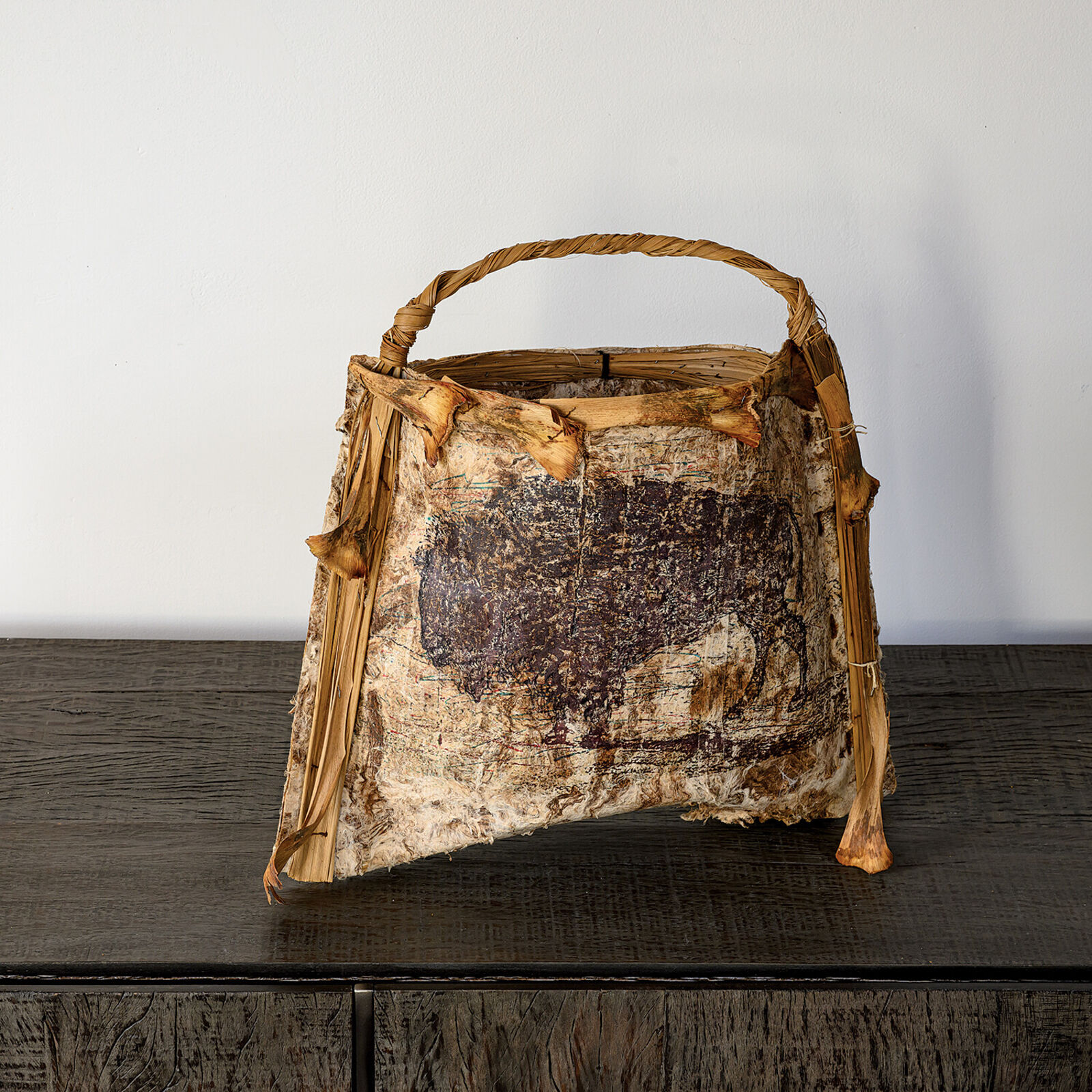 A brown and white bag sitting on top of a wooden table.