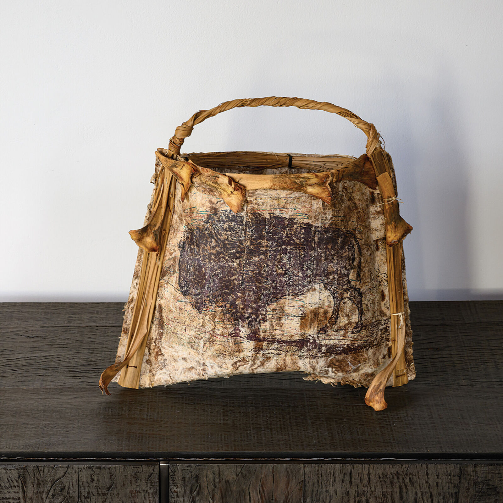 A brown and white bag sitting on top of a wooden table.