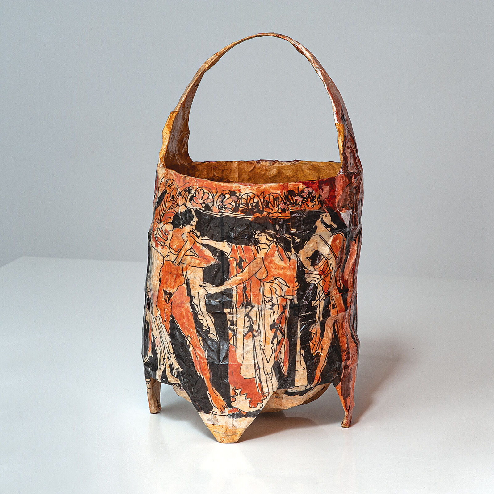 A brown and black bag with a painting on it.