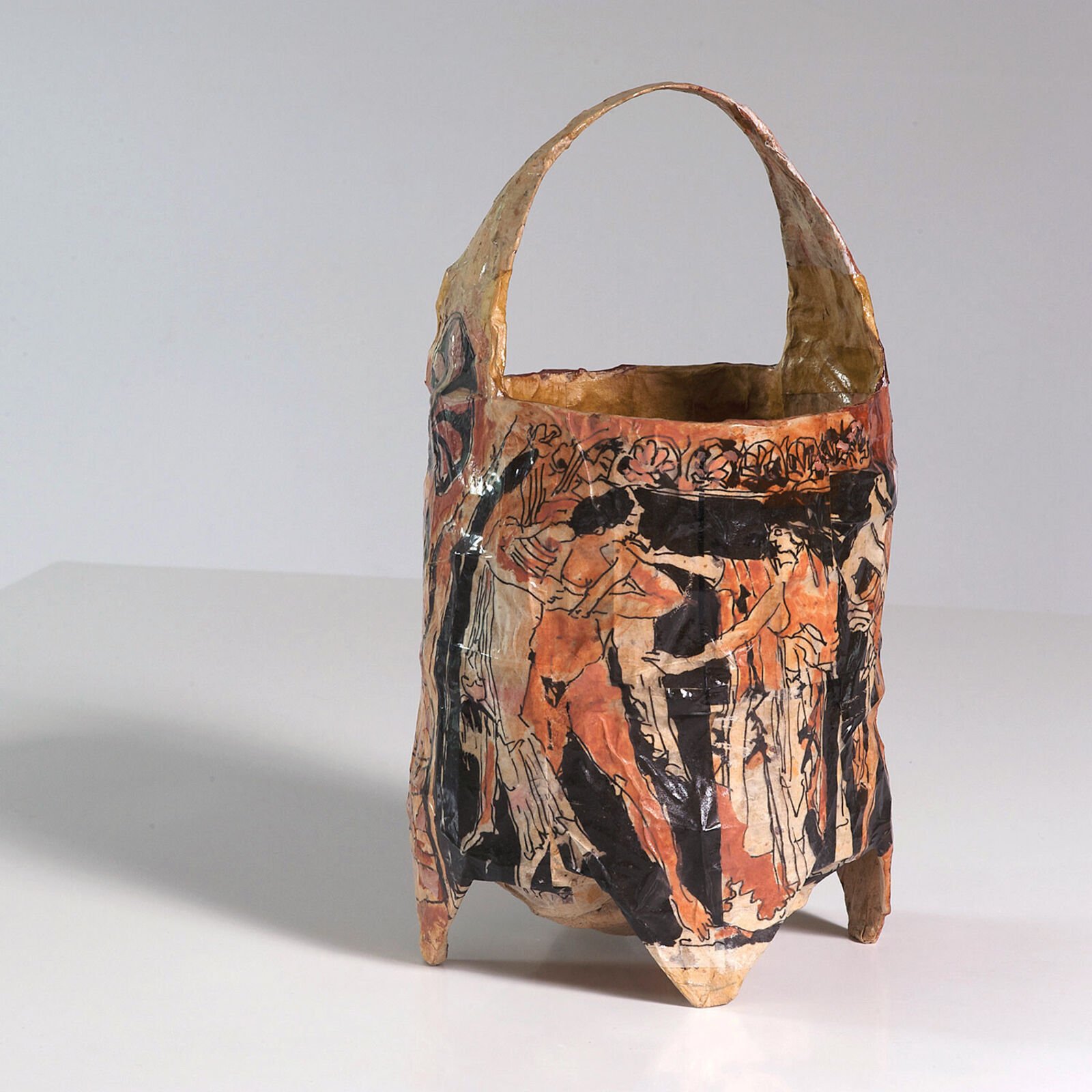 A brown and black bag with a painting on it.