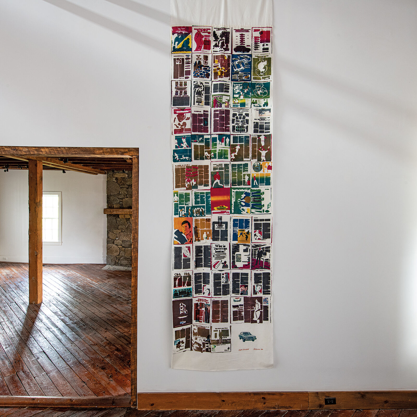 A large piece of art hanging on a wall in a room.