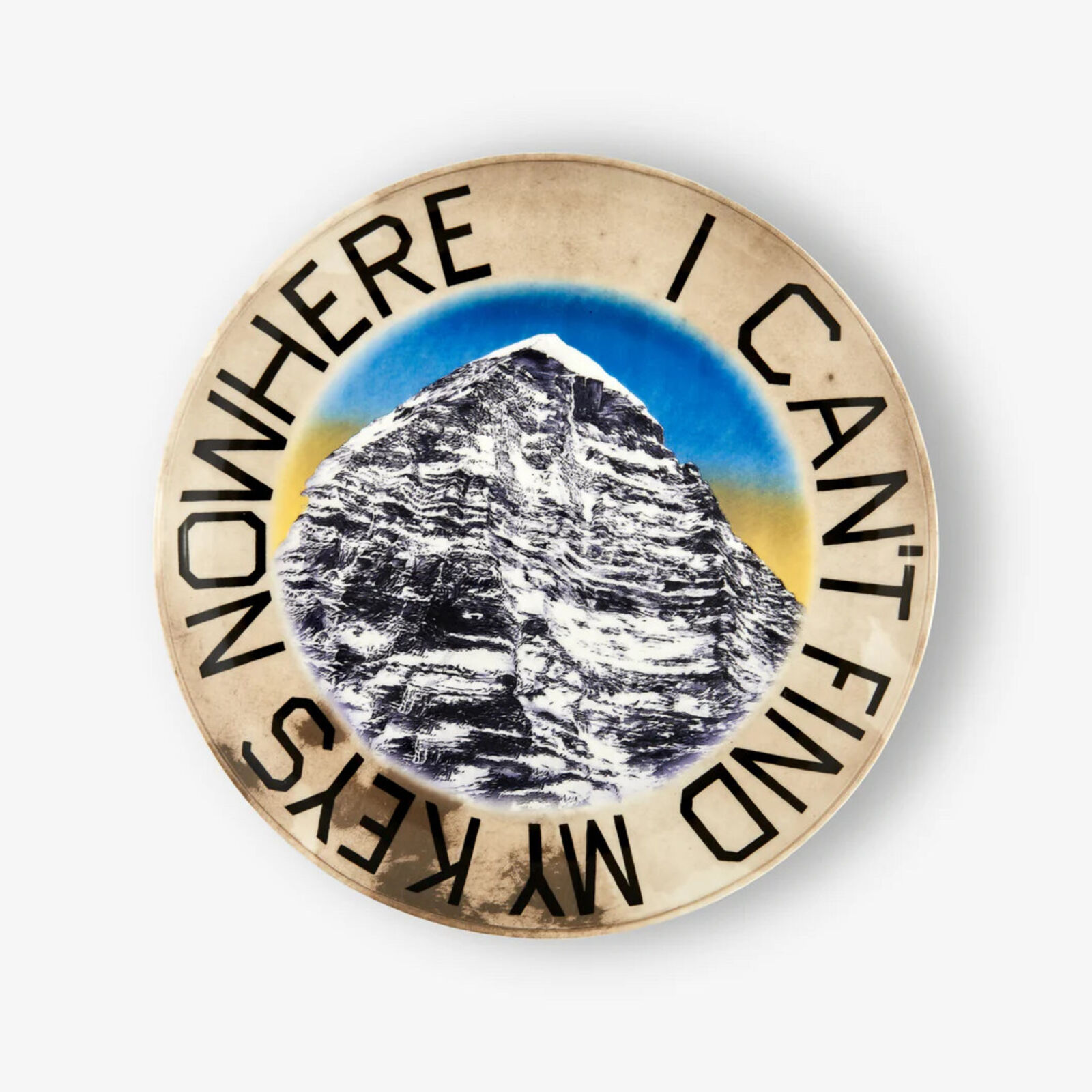 A plate with a picture of a mountain on it.