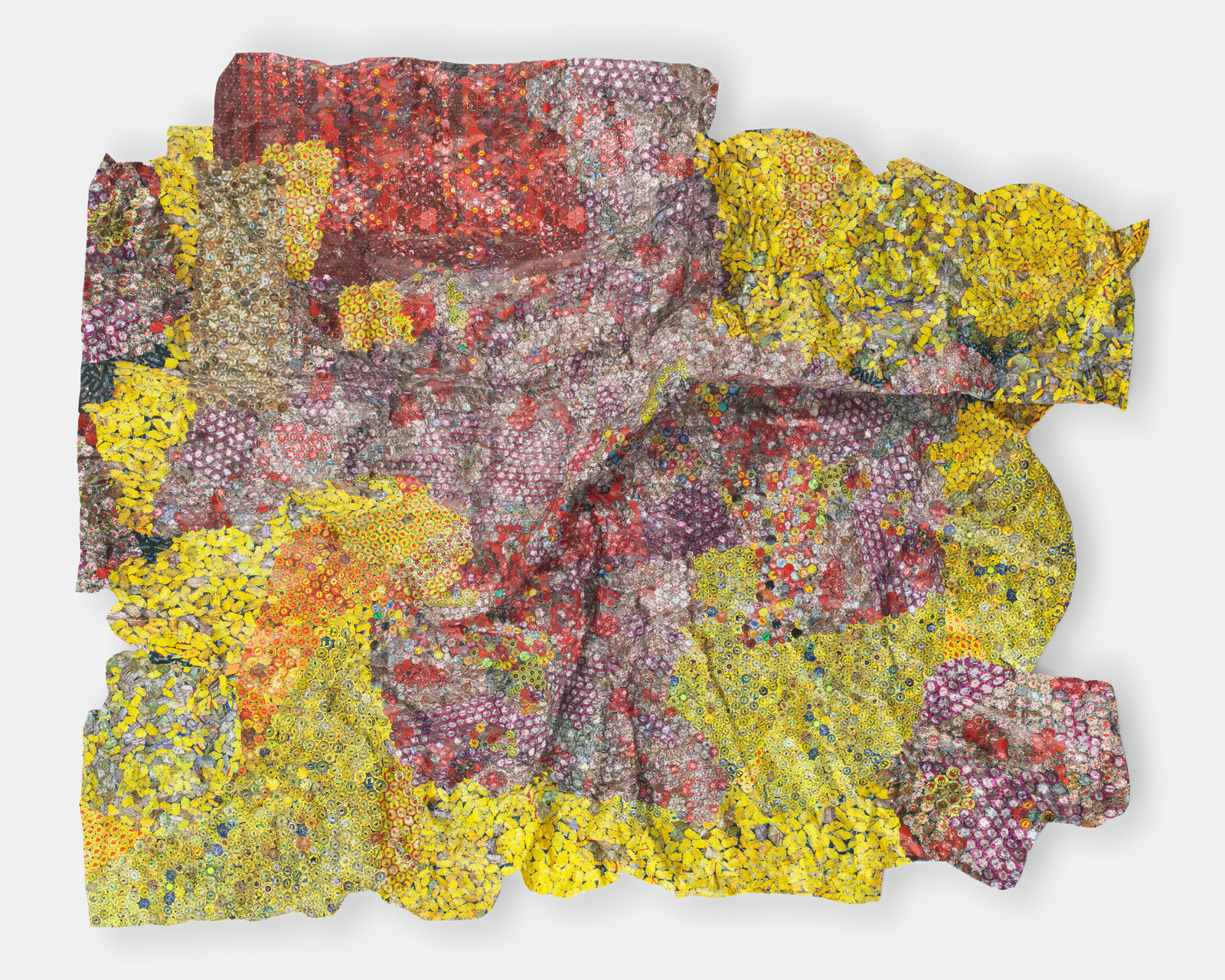 A colorful, crumpled textile-like artwork made from thousands of tiny bottle caps.