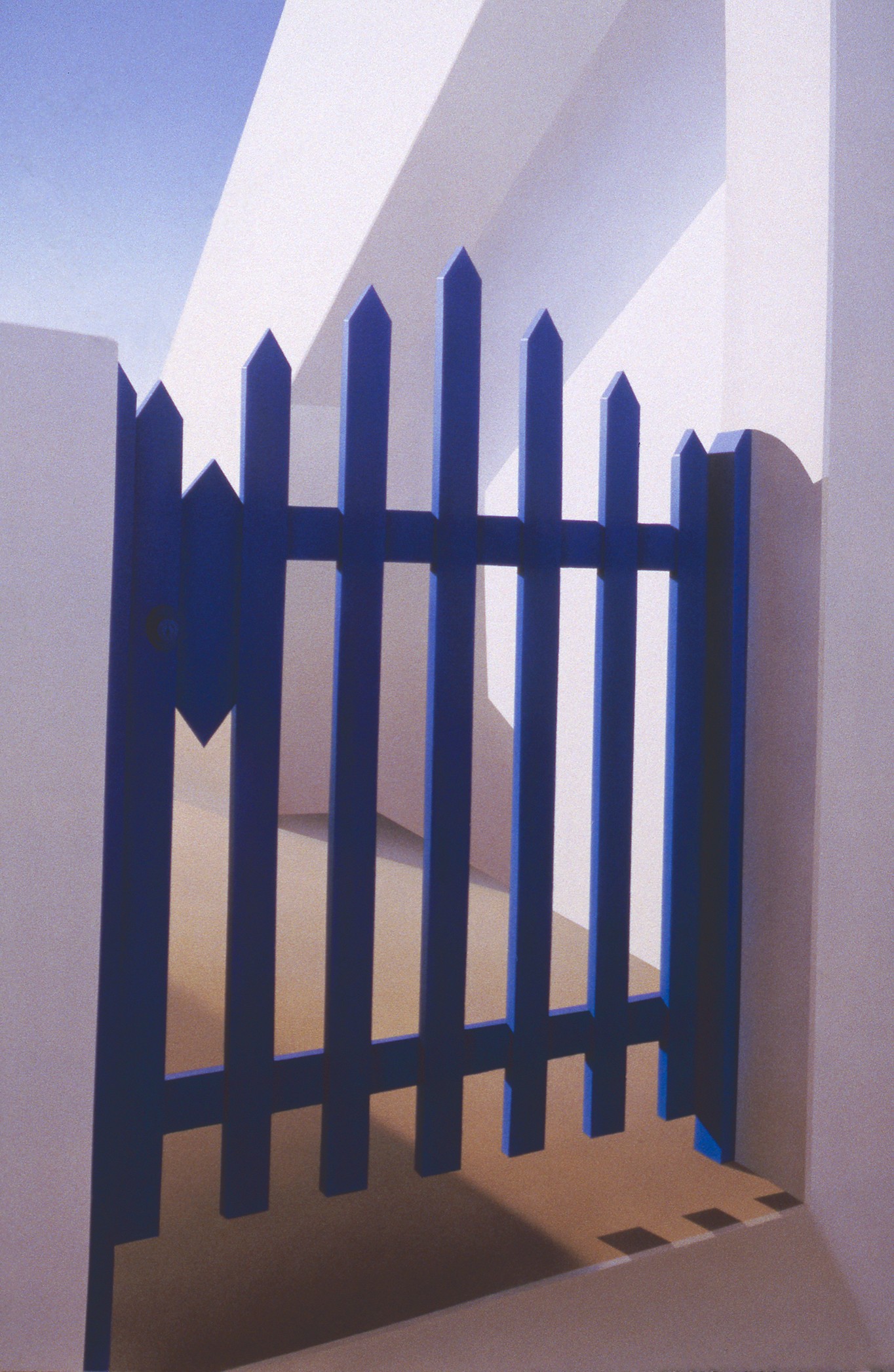 A blue picket fence in front of a white wall.