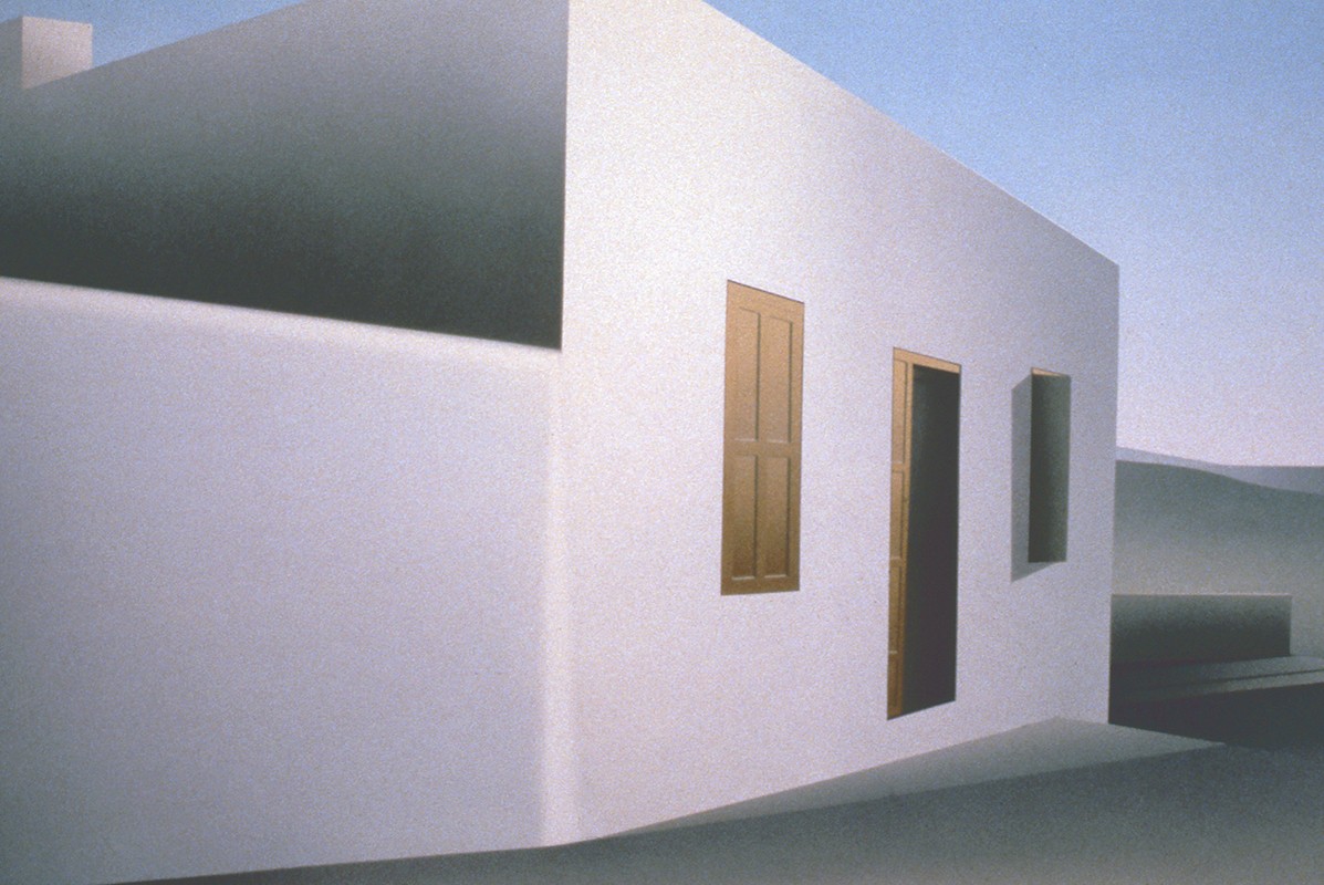A white building with two windows and a door.