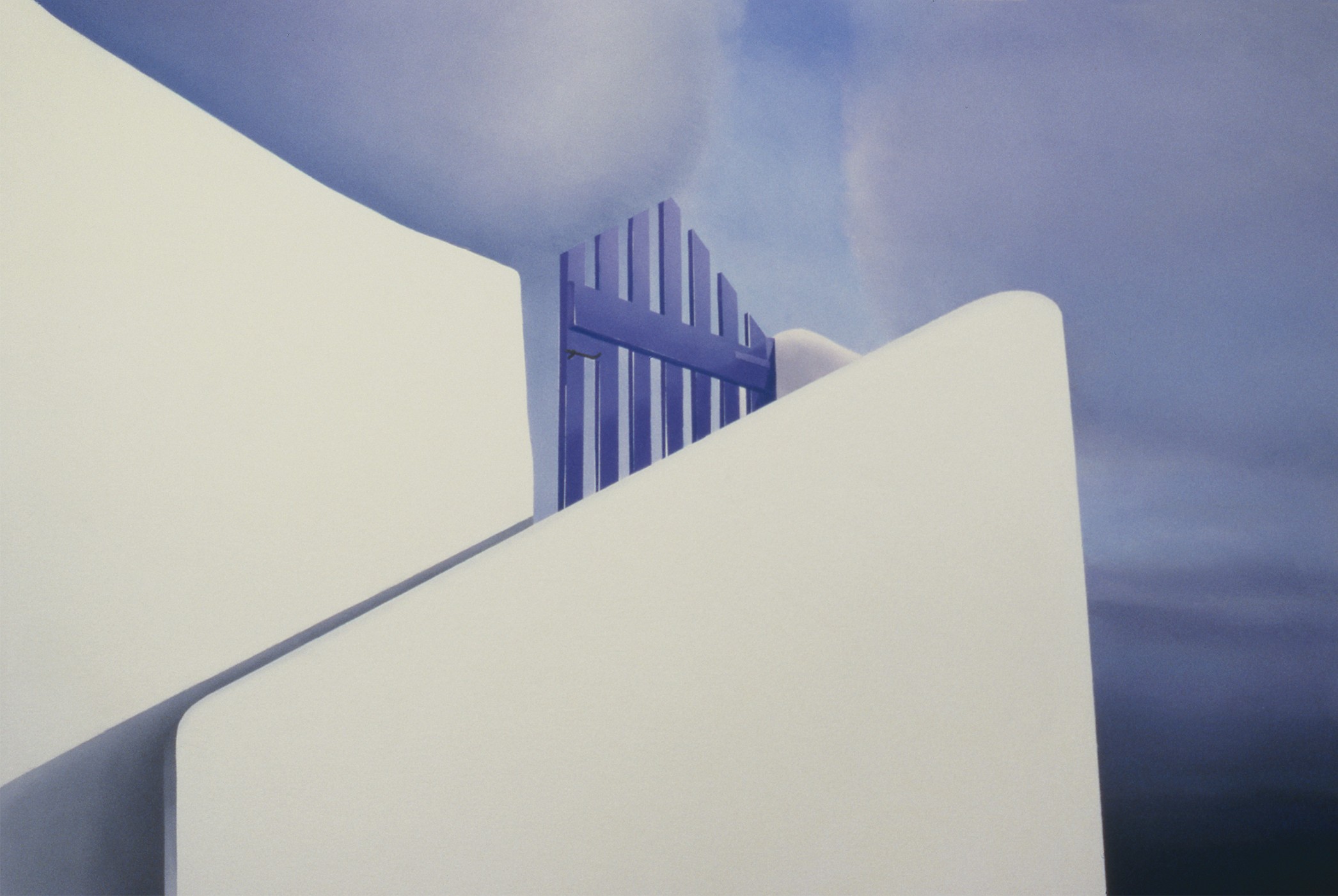 A white building with a blue gate in the middle of it.