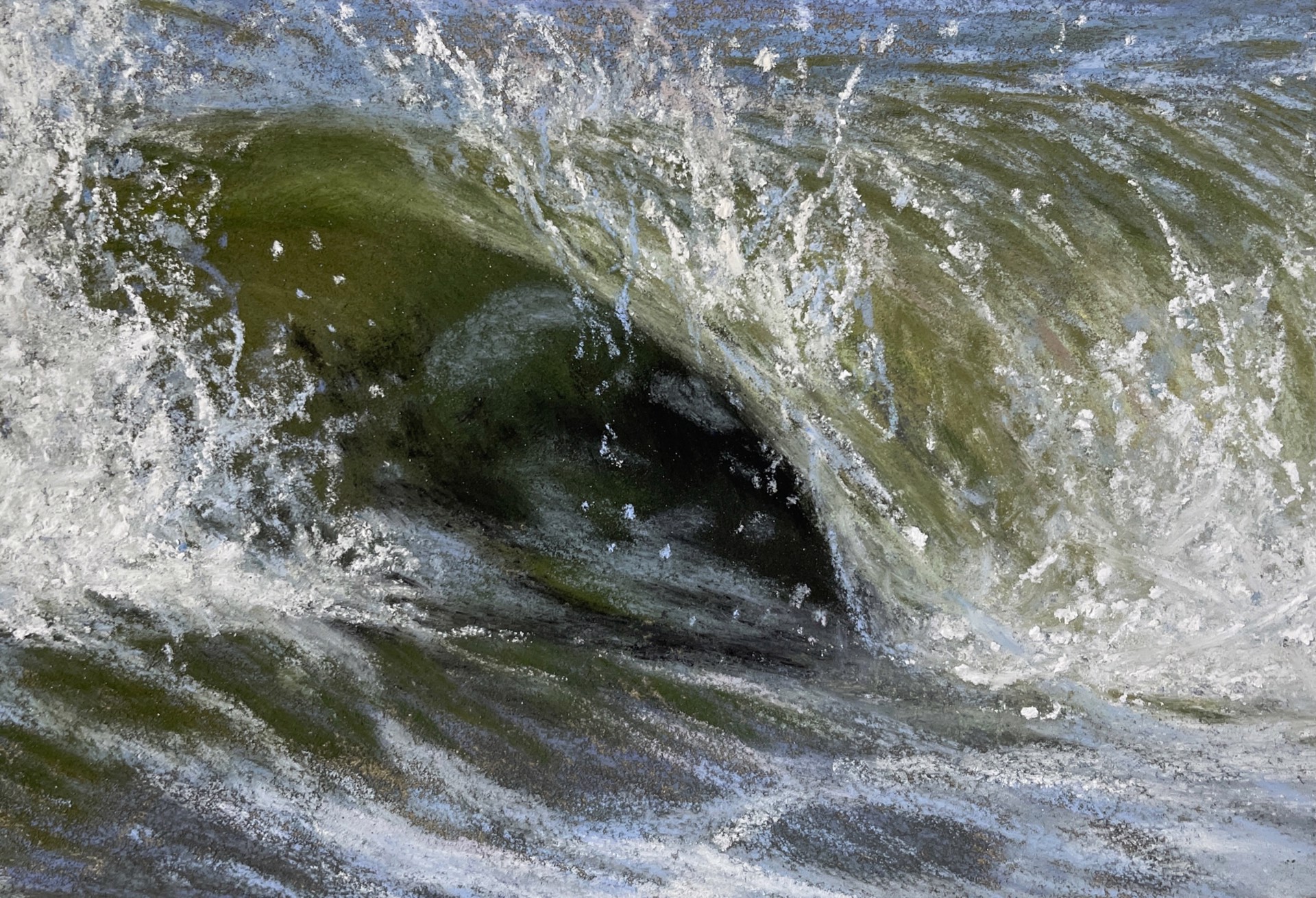 A close up of a large wave breaking over a rock in the water.