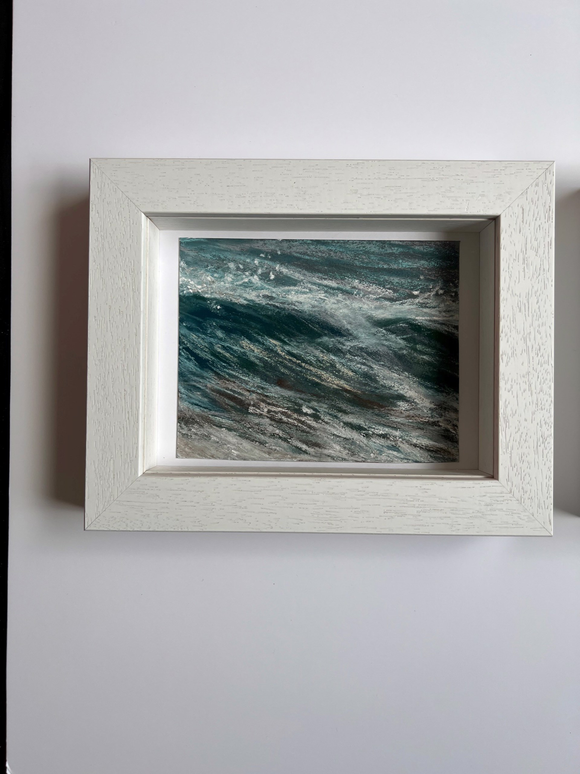 A dynamic close-up of turbulent water with swirling textures and white foam.