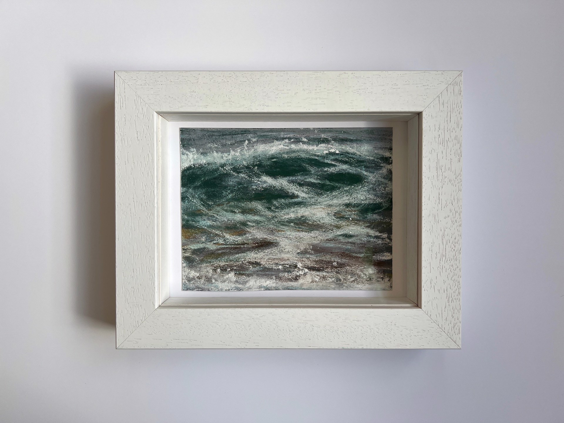 A painting of a large body of water with waves crashing on the shore.