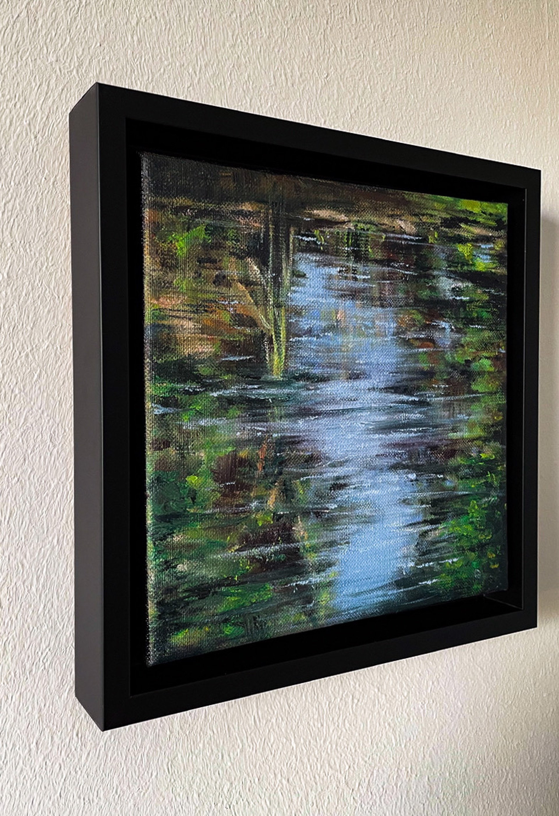 A textured painting of a narrow stream reflecting light, surrounded by dense foliage.